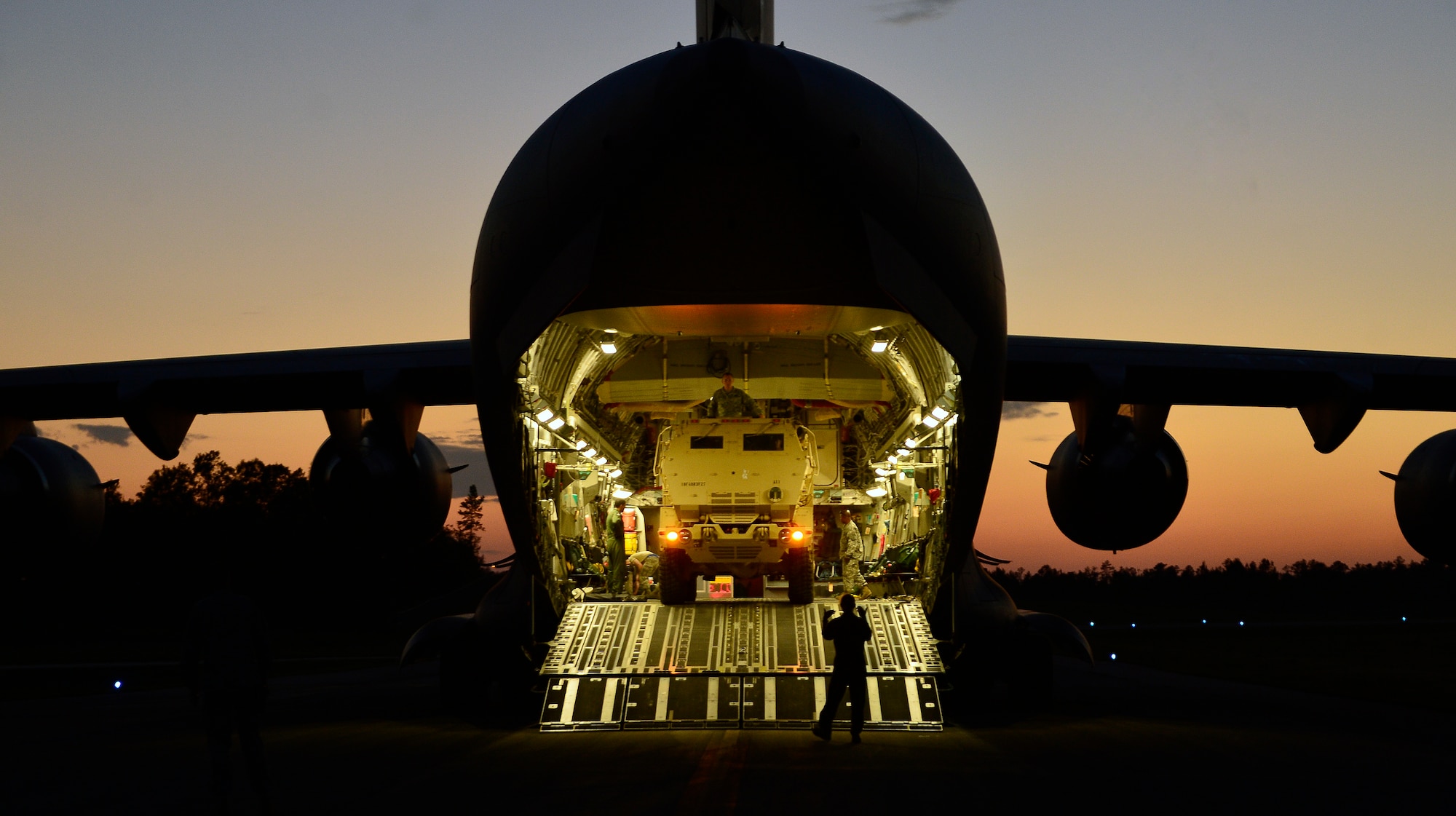 U.S. Air Force Staff Sgt. Robert Clark, 8th Airlift Squadron C-17 Globemaster III loadmaster, directs a U.S. Army M142 High Mobility Artillery Rocket System out of a C-17 during Emerald Warrior 2013, Hurlburt Field, Fla., April 25. The primary purpose of Emerald Warrior is to exercise special operations components in urban and irregular warfare settings to support combatant commanders. Emerald Warrior leverages lessons from Operation Iraqi Freedom,Operation Enduring Freedom and other historical lessons to provide better trained and ready forces to combatant commanders. (U.S. Air Force photo by Staff Sgt. Vernon Young Jr.)(Released)