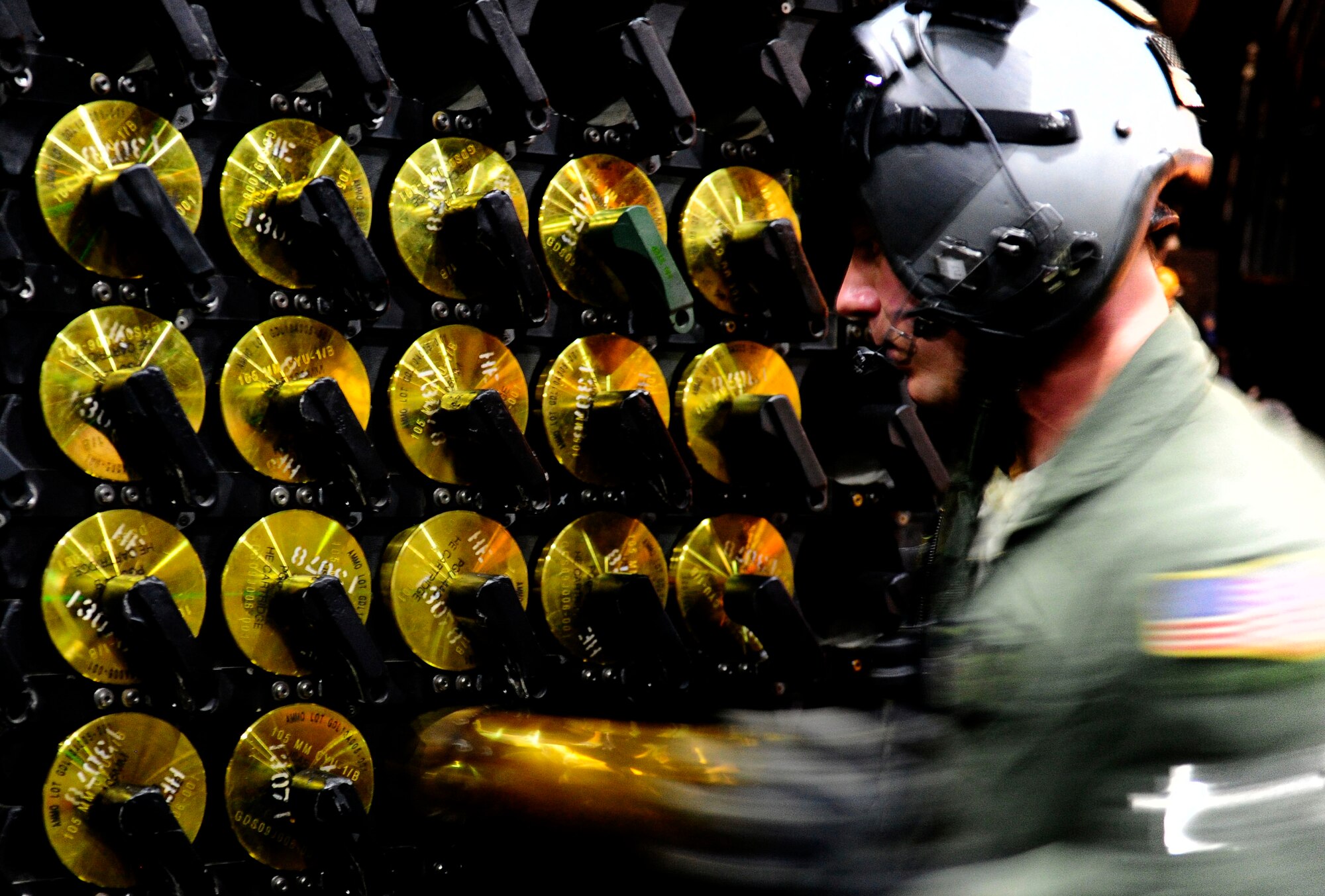 A U.S. Air Force aerial gunner on a AC-130H Spectre Gunship loads 105mm ammunition onboard their aircraft during Emerald Warrior 2013 at Hulburt Field, Fla., April 24. The primary purpose of Emerald Warrior is to exercise special operations components in urban and irregular warfare settings to support combatant commanders. Emerald Warrior leverages lessons from Operation Iraqi Freedom,Operation Enduring Freedom and other historical lessons to provide better trained and ready forces to combatant commanders. (U.S. Air Force photo by Staff Sgt. Andy M. Kin)
