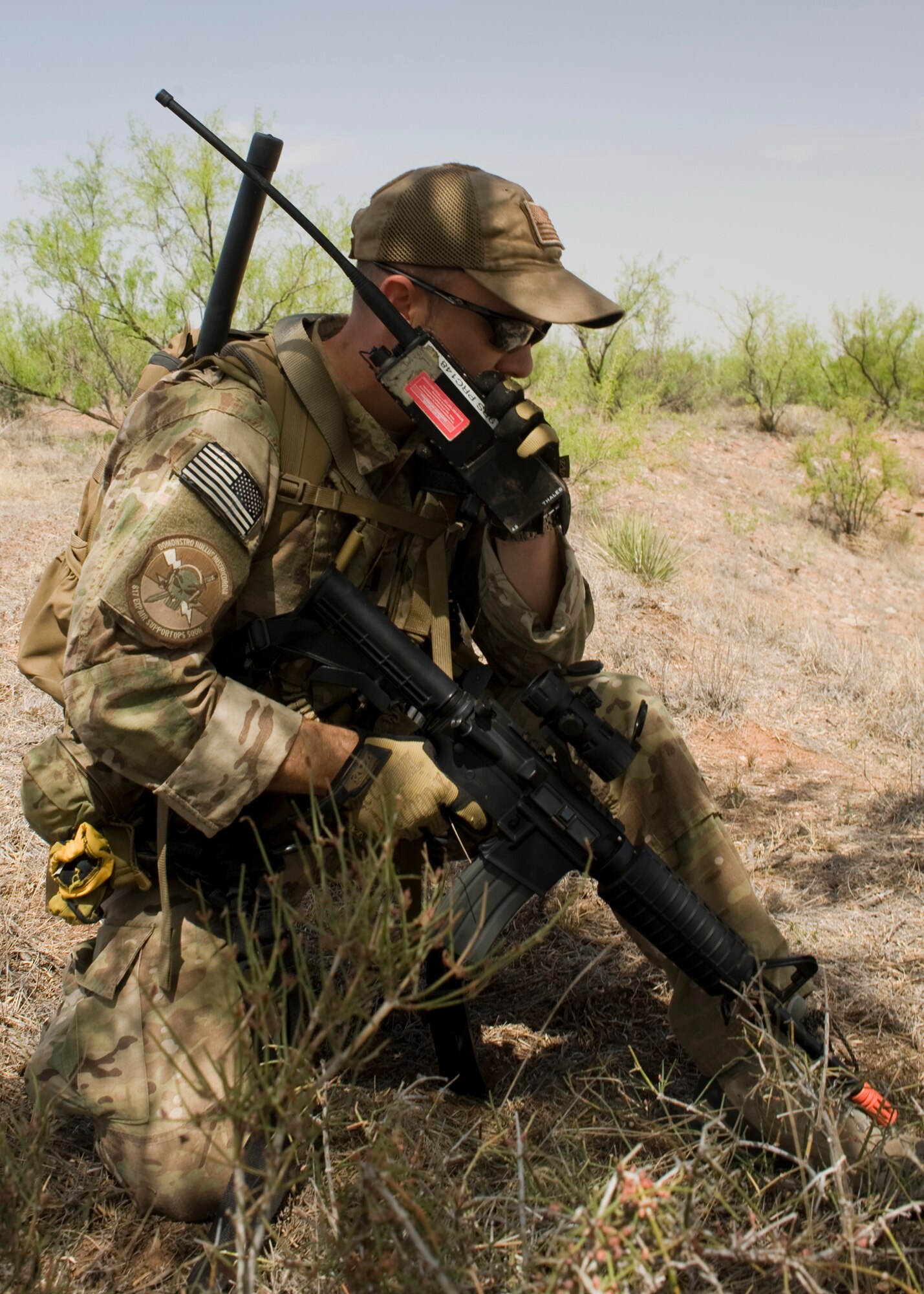 U.S. Air Force Capt. Thomas White, 9th Bomb Squadron, Dyess Air Force Base, Texas, communicates with a Dyess B-1 Bomber to eliminate enemy combatants during a joint training exercise May 1, 2013, near Snyder, Texas. During the exercise, Joint Terminal Attack Controllers directed B-1 Bombers to provide close air support on simulated high-value targets during several realistic scenarios. (U.S. Air Force photo by Airman 1st Class Peter Thompson/Released)