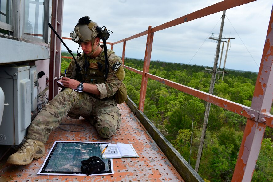 A U.S. Air Force Joint Terminal Attack Controller (JTAC) reviews coordinate points prior to calling in air support during Emerald Warrior 2013 at Hurlburt Field, Fla., April 24. The primary purpose of Emerald Warrior is to exercise special operations components in urban and irregular warfare settings to support combatant commanders. Emerald Warrior leverages lessons from Operation Iraqi Freedom,Operation Enduring Freedom and other historical lessons to provide better trained and ready forces to combatant commanders.(U.S. Air Force photo by Staff Sgt. Vernon Young Jr.)(Released)