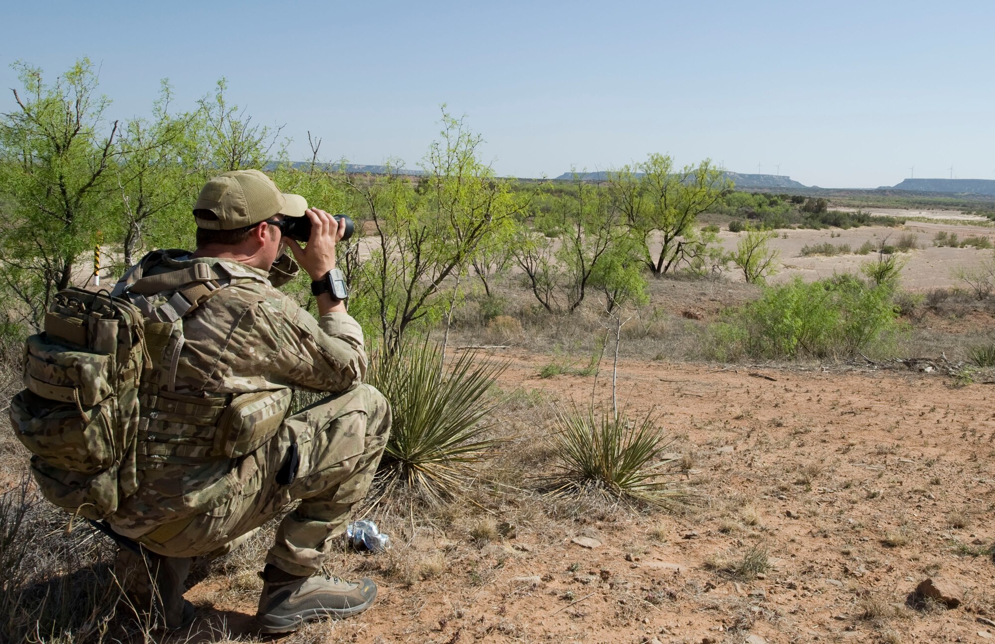 A U.S. Air Force Joint Terminal Attack Controller from Fort Sill, Okla., scans the area for enemy combatants during a joint training exercise May 1, 2013, near Snyder, Texas. B-1 Bombers from Dyess Air Force Base, Texas, provided close air support during the exercise. (U.S. Air Force photo by Staff Sgt. Richard Ebensberger/Released)