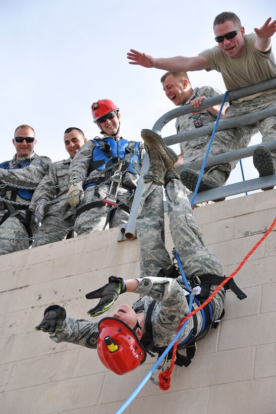 YOUNGSTOWN AIR RESERVE STATION, Ohio -- Tech. Sgt. Timothy Wertz, 910th Civil Engineer Squadron crew chief, instructs Master Sgt. Holly Holcomb, 910th CES first sergeant, through an inverted repelling exercise during annual fire training May 5, 2013, here. (U.S. Air Force photo/Staff Sgt. Megan Tomkins)