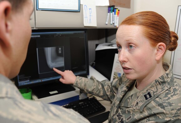 Capt. Laura Dossett, 81st Surgical Operations Squadron occupational therapist, reviews x-Ray results with a patient May 3, 2013, at the Keesler Medical Center, Keesler Air Force Base, Miss.  Dossett is Keesler’s only occupational therapist and works primarily with arm, wrist and hand ailments that restrict every-day tasks.  (U.S. Air Force photo by Kemberly Groue)