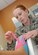 Capt. Laura Dossett, 81st Surgical Operations Squadron occupational therapist, applies kinesio tape on a patient’s arm for edema management May 3, 2013, at the Keesler Medical Center, Keesler Air Force Base, Miss.  Dossett is Keesler’s only occupational therapist and works primarily with arm, wrist and hand ailments that restrict every-day tasks.  (U.S. Air Force photo by Kemberly Groue)