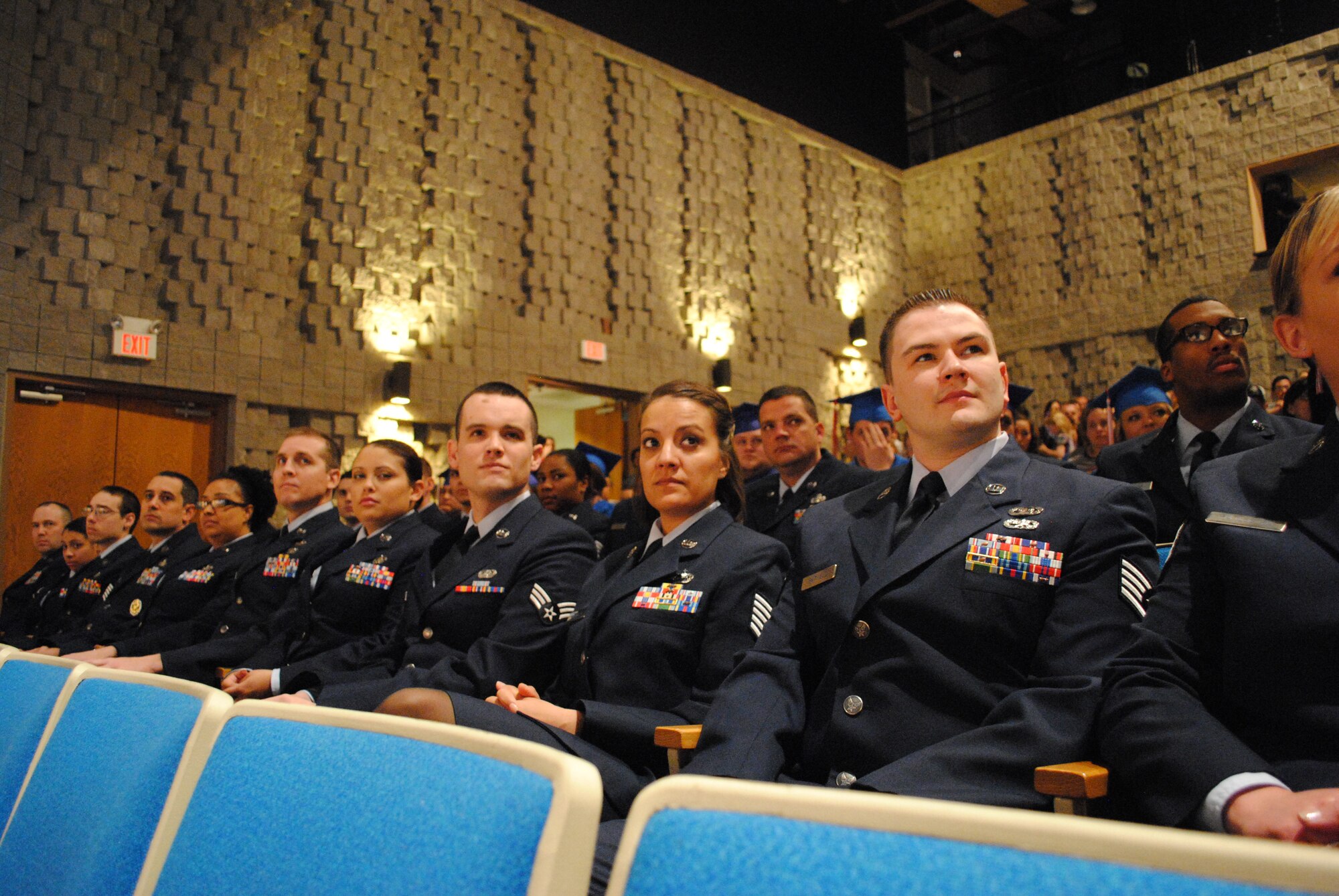 Dressed in their service dress blues, Airmen from Grand Forks Air Force Base, N.D., listen to remarks from the guest speaker during a combined school graduation ceremony held April 27, 2013, in East Grand Forks, Minn. Thirty-two Airmen received their associate’s degree from the Community College of the Air Force at the ceremony. Grand Forks AFB colleges have awarded 178 people with degrees this past year.  (U.S. Air Force photo/Staff Sgt. Luis Loza Gutierrez)
