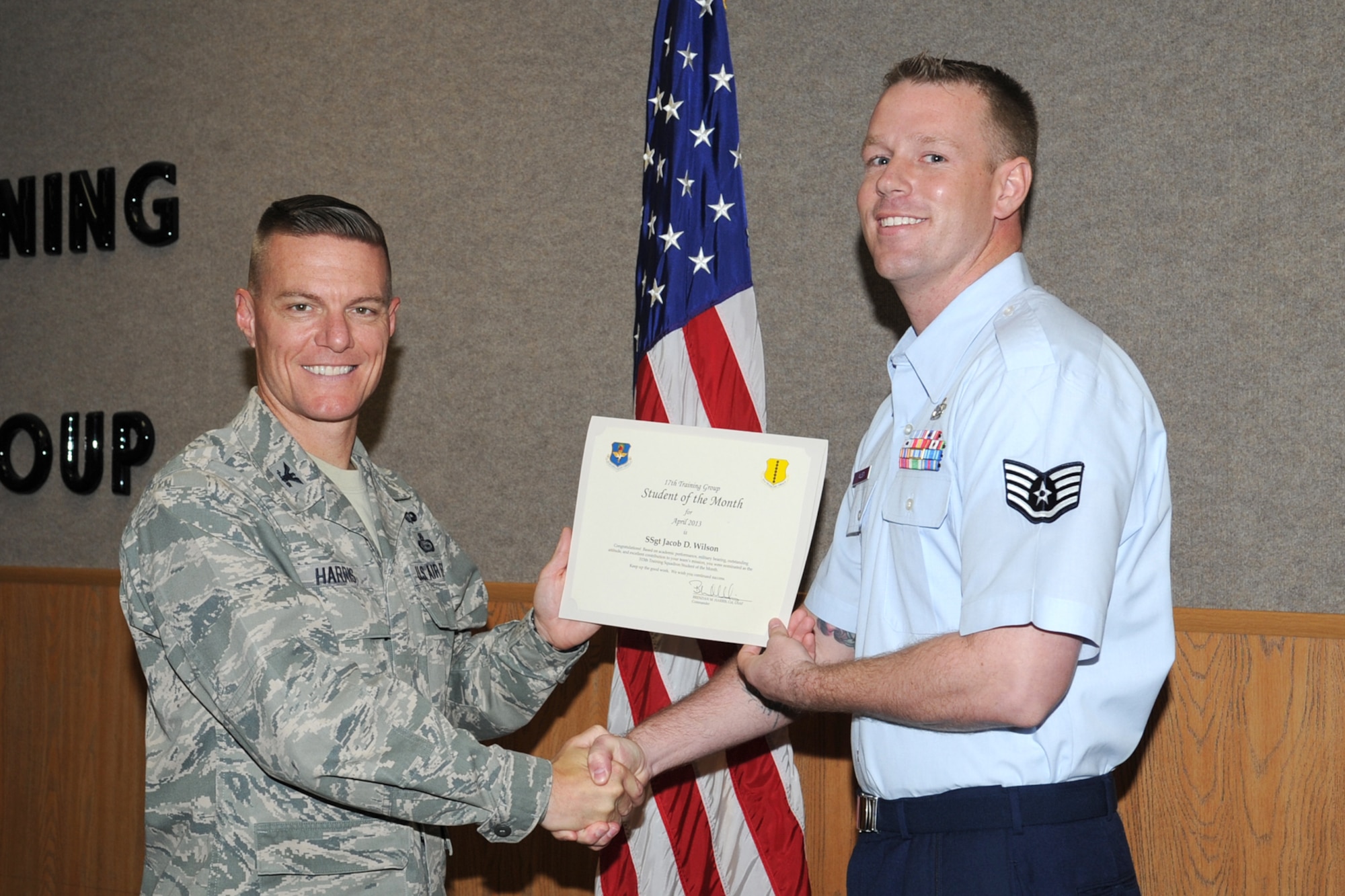 GOODFELLOW AIR FORCE BASE, Texas-- Col. Brendan Harris, 17th Training Group Commander, presents Staff Sgt. Jacob Wilson with the 315th Training Squadron Enlisted Student of the Month award for April, May 3. (U.S. Air Force photo/Staff Sgt. Laura R. McFarlane)