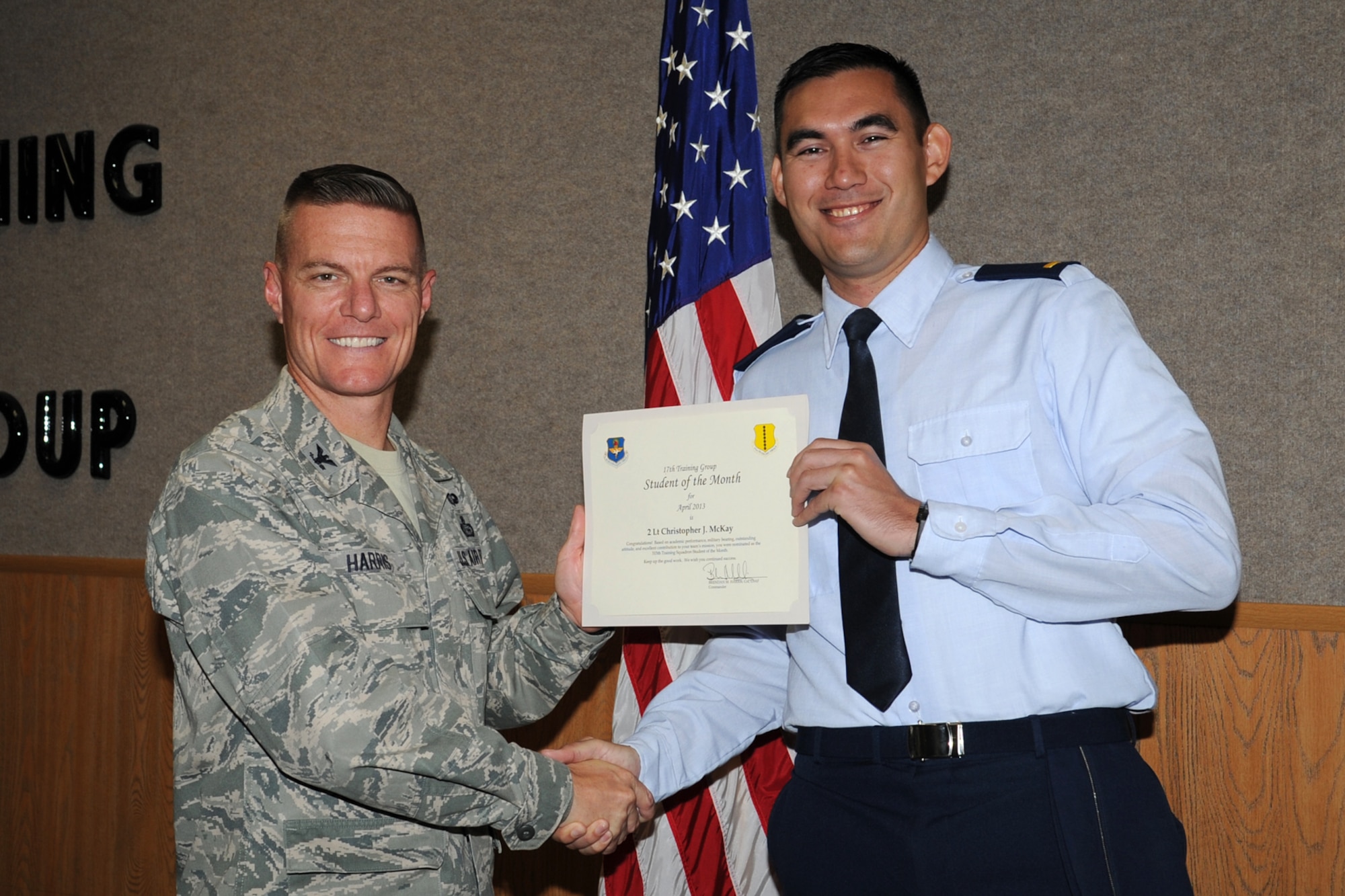 GOODFELLOW AIR FORCE BASE, Texas-- Col. Brendan Harris, 17th Training Group Commander, presents 2nd Lt. Christopher McKay with the 315th Training Squadron Officer Student of the Month award for April, May 3. (U.S. Air Force photo/Staff Sgt. Laura R. McFarlane)