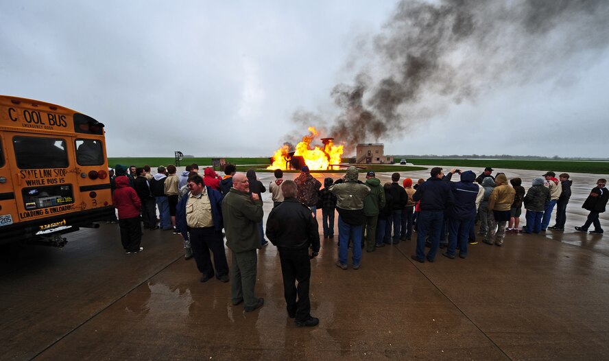 Cub Scouts from the St. Louis, Warrensburg, Sedalia and Knob Noster area watch a fire training exercise hosted by the 509th Civil Engineer Squadron fire department during Scout Day at Whiteman Air Force Base, Mo., April 30, 2013. Volunteers from various units on base collaborated to speak to the scouts about the Air Force mission, the various career fields the Air Force offers and make the event a success.  (U.S. Air Force photo by Staff Sgt. Nick Wilson/Released)