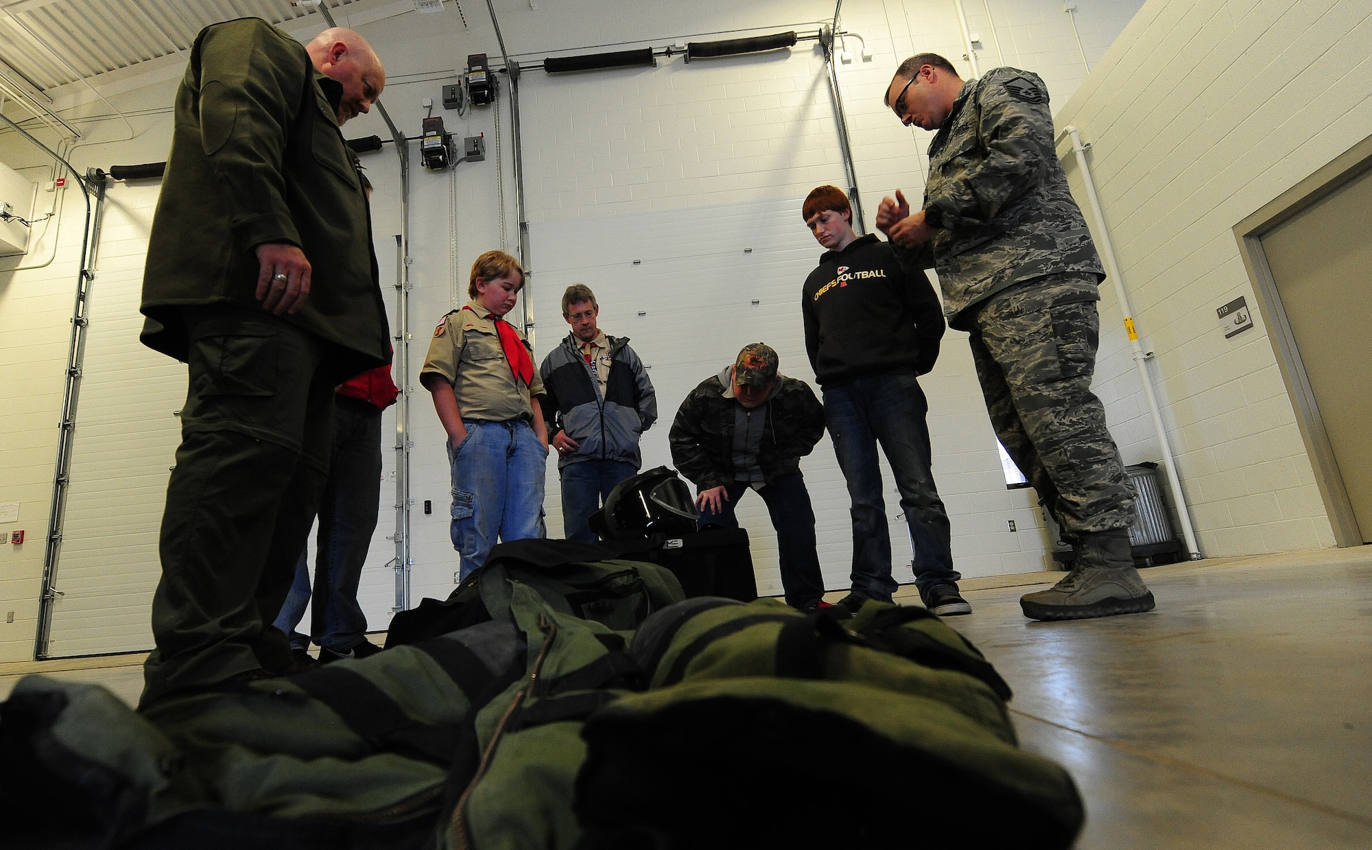 Boy Scouts from St. Louis, Mo. are briefed on explosive ordinance disposal during Scout Day at Whiteman Air Force Base, Mo., April 30, 2013. Cub Scouts from the St. Louis, Warrensburg, Sedalia and Knob Noster area have annually gathered at Whiteman Air Force Base to learn about the 509th Bomb Wing’s mission and learn from various organizations on base. (U.S. Air Force photo by Staff Sgt. Nick Wilson/Released)