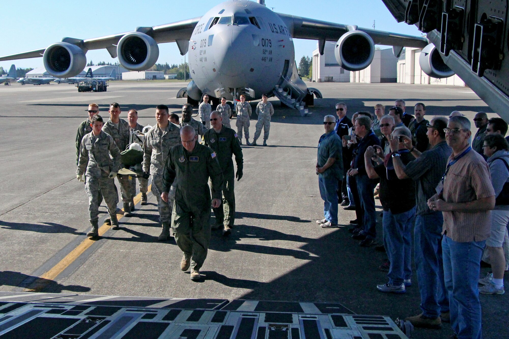 446th Airlift Wing Reservist's civilian employers watch as a team from the 446th Aeromedical Staging Squadron loads a patient onto a C-17 Globemaster III May 4 at Hangar 12. The demonstration is one of many the employers got to see during employer orientation day. (U.S. Air Force photo by Airman 1st Class Madelyn McCullough)