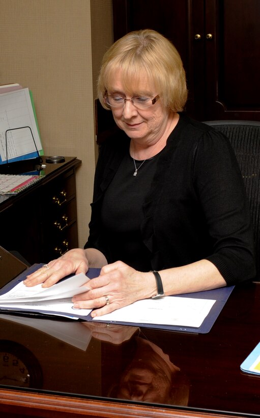 Marian Tolley, 28th Bomb Wing Secretary, organizes documents in the 28th BW Headquarters at Ellsworth Air Force Base, S.D., Feb. 6, 2013. Among keeping the wing commander on track with all his appointments and meetings, Tolley also manages staff calendars, makes travel arrangements and proof reads important documents. (U.S. Air Force photo by Airman 1st Class Anania Tekurio/Released)