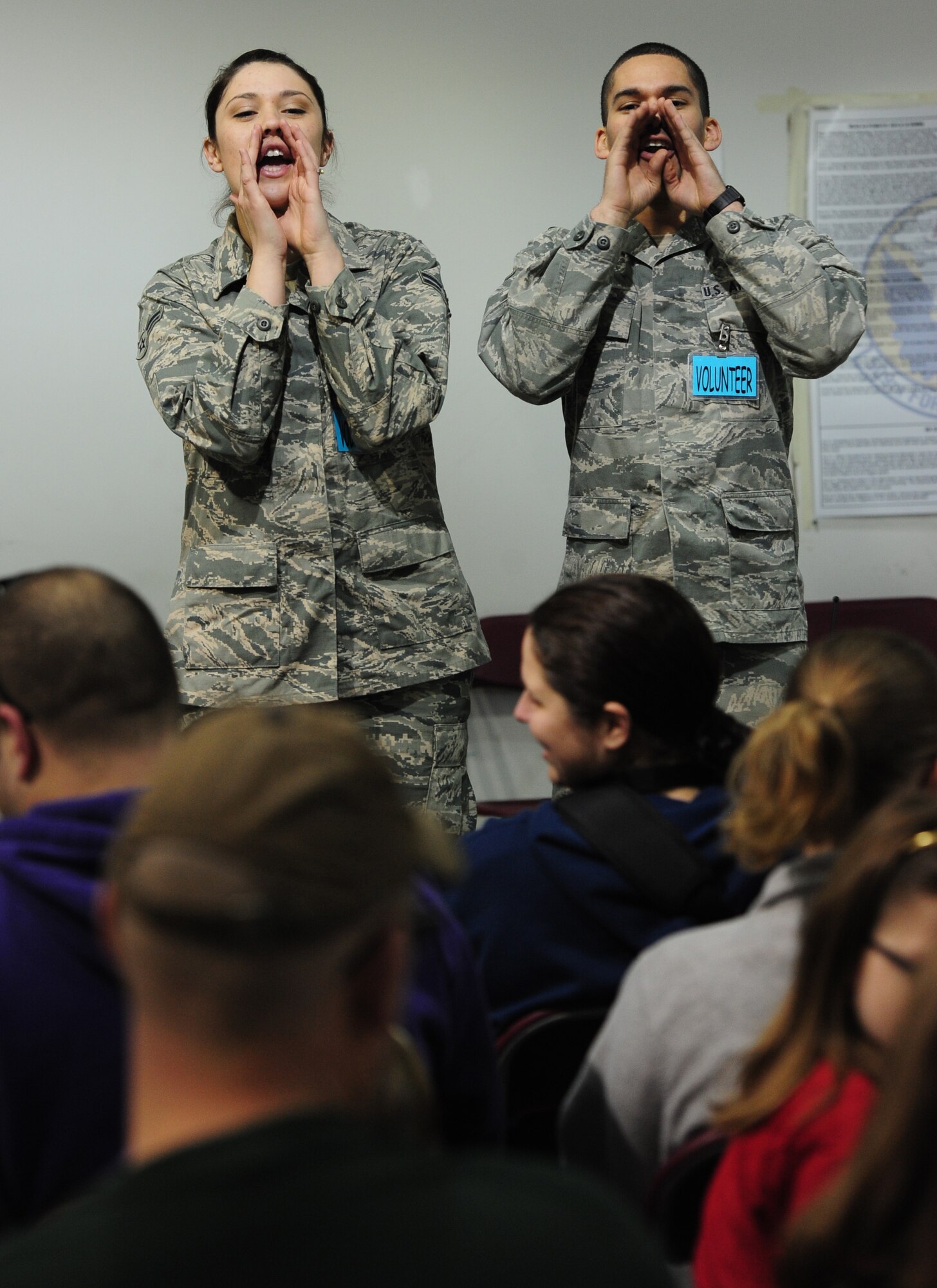 Airmen 1st Class Stephanie Tornero, 509th Force Support Squadron, and Randolph Baez, 509th Civil Engineer Squadron, motivate their assigned deployment groups to yell a chalk chant during Operation Spirit at Whiteman Air Force Base, Mo., April 20, 2013. During the eighth annual Operation Spirit children were recalled at 8 a.m. for a mock deployment. (U.S. Air Force photo by Staff Sgt. Nick Wilson/Released)