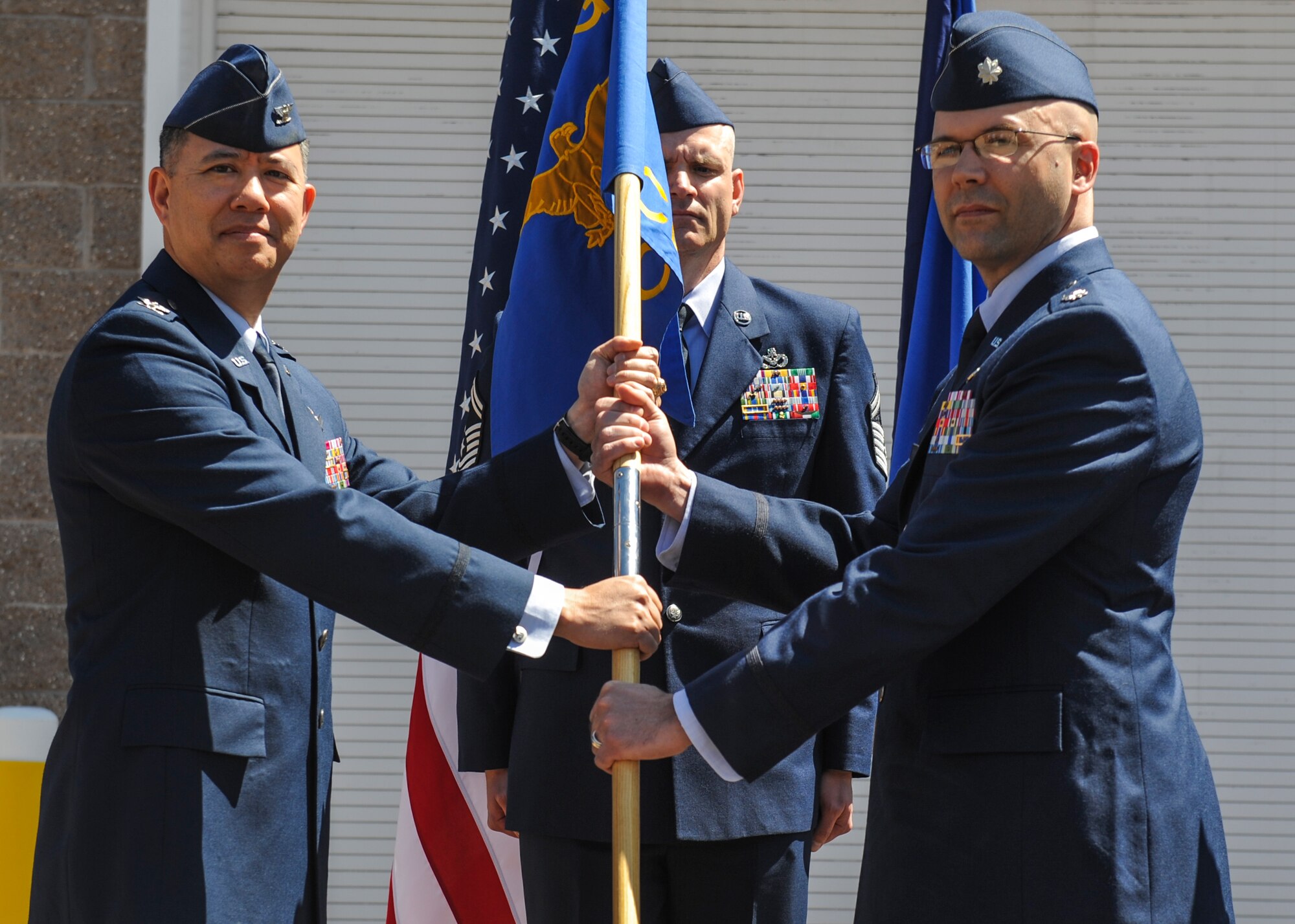 Col. Robert Uemura, left, 460th Mission Support Group commander, hands the 460th Civil Engineer Squadron guidon to the new squadron commander, Lt. Col. Allen Thibeaux at the squadron's change of command ceremony May 3, 2012 on Buckley Air Force Base, Colo. (U.S. Air Force photo by Staff Sgt. Christopher Gross/Released)