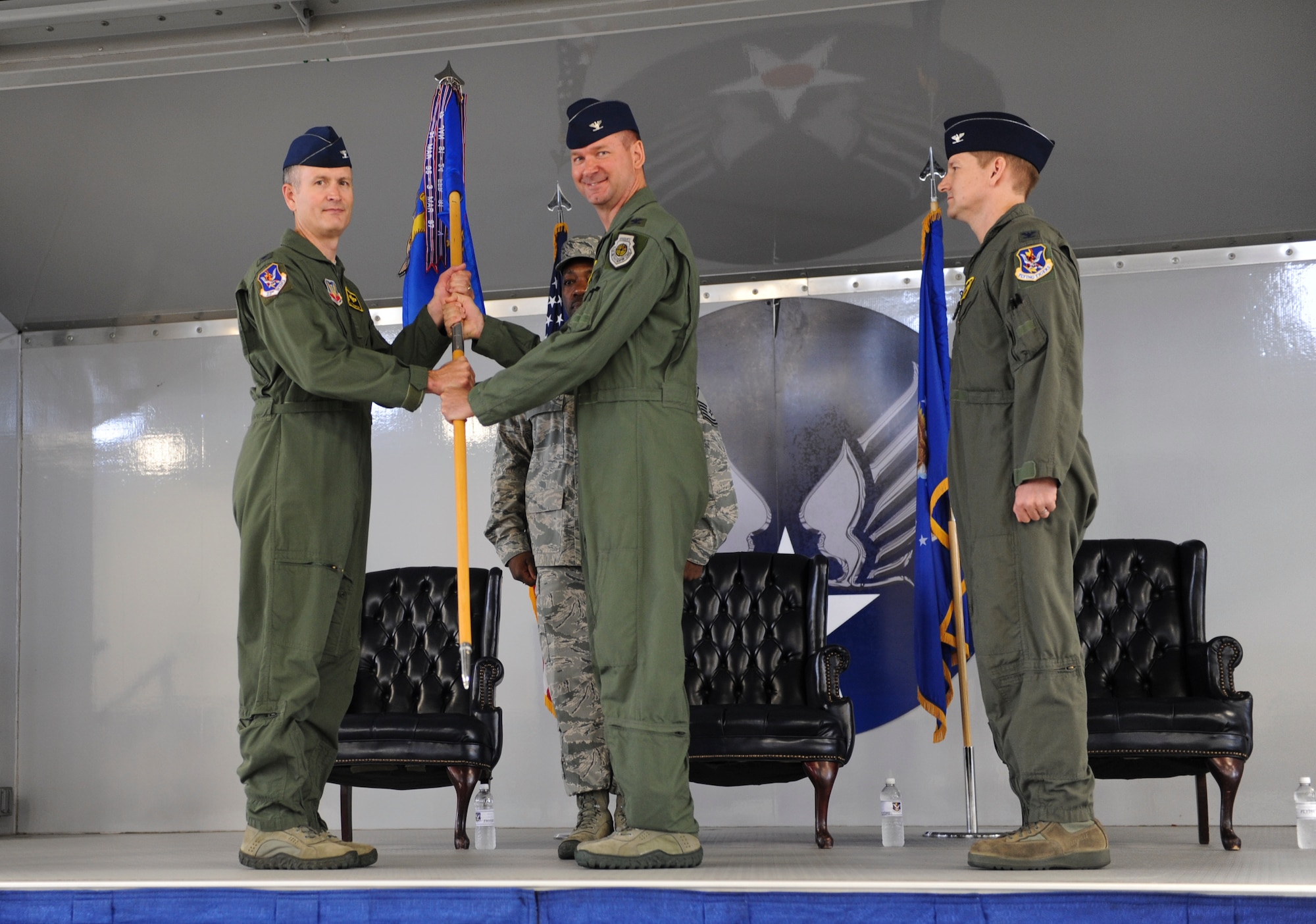 U.S. Air Force Col. Ron Stuewe, outgoing 23d Fighter Group commander, passes the guidon to Col. Billy Thompson, 23d Wing commander, during a change of command ceremony at Moody Air Force Base, Ga., May 3, 2013. Passing the guidon to Thompson symbolized relinquishing responsibilities of the unit. (U.S. Air Force photo by Airman Alexis Grotz/Released)