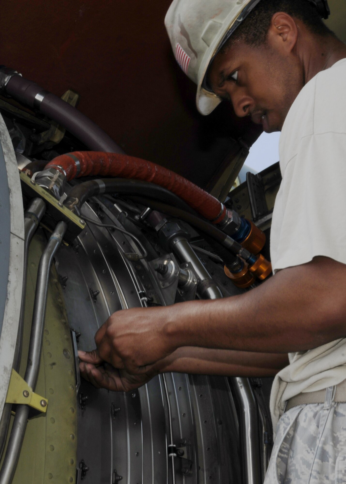 Tech. Sgt. Leonardo Riley, 100th Maintenance Group, attaches the engine ring cowl to a General Electric CFM-56 engine April 22, 2013, in Southwest Europe after an engine swap was performed on a KC-135R Stratotanker. The engine in the No. 4 position was damaged April 9, 2013 by a bird strike resulting in the engine swap. (U.S. Air Force photo by 1st Lt. Christopher Mesnard/Released)