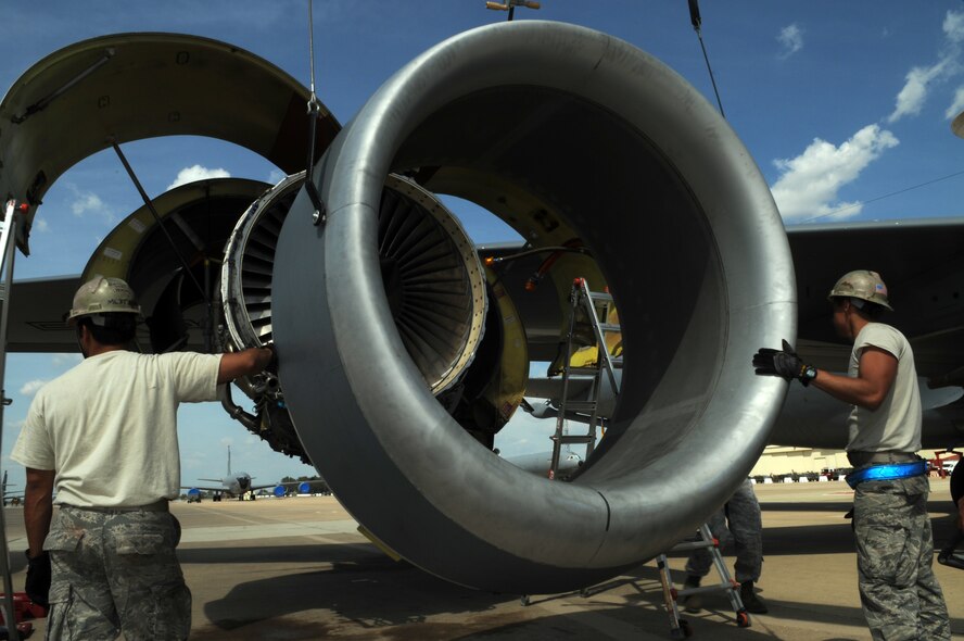 From left, Tech. Sgt. Eugene Marques and Senior Airman Samuel Dahlgren-Castilla, 100th Maintenance Squadron, move the engine ring cowl into position on the No. 4 engine of a KC-135R Stratotanker April 22, 2013, in Southwest Europe.  The cowl helps make the engine more aerodynamic as air flows over it during flight. (U.S. Air Force photo by 1st Lt. Christopher Mesnard/Released)