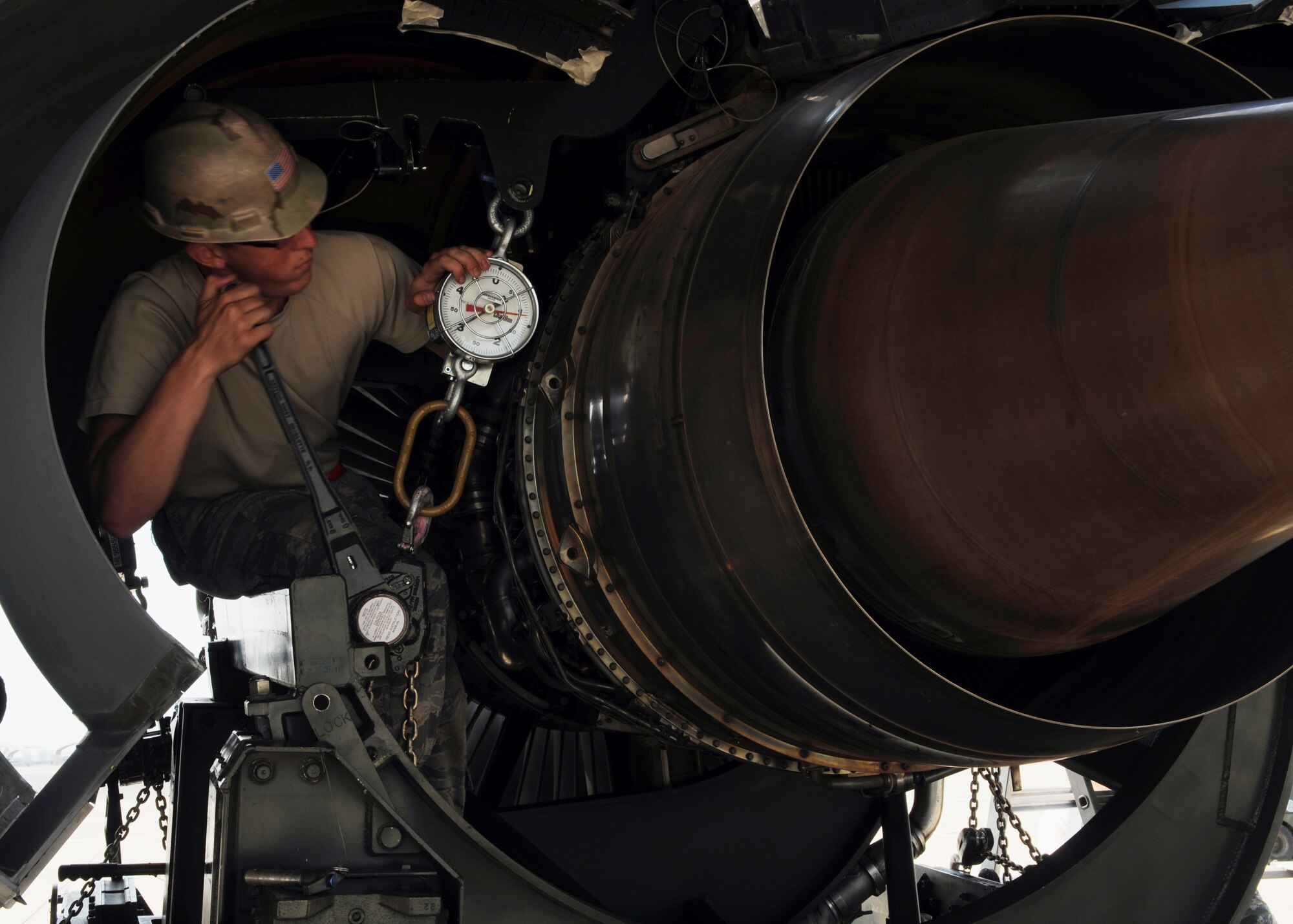 Airman 1st Class Colton Williams, 100th Maintenance Squadron, ratchets a cradle for transporting a damaged KC-135R Stratotanker engine up to the engine April 21, 2013, in Southwest Europe, to allow the No. 4 engine to be easily wheeled around once it is detached from the wing of the aircraft. The engine was replaced over a four-day period by the 351st Expeditionary Air Refueling Squadron’s deployed maintainers. (U.S. Air Force photo by 1st Lt. Christopher Mesnard/Released)