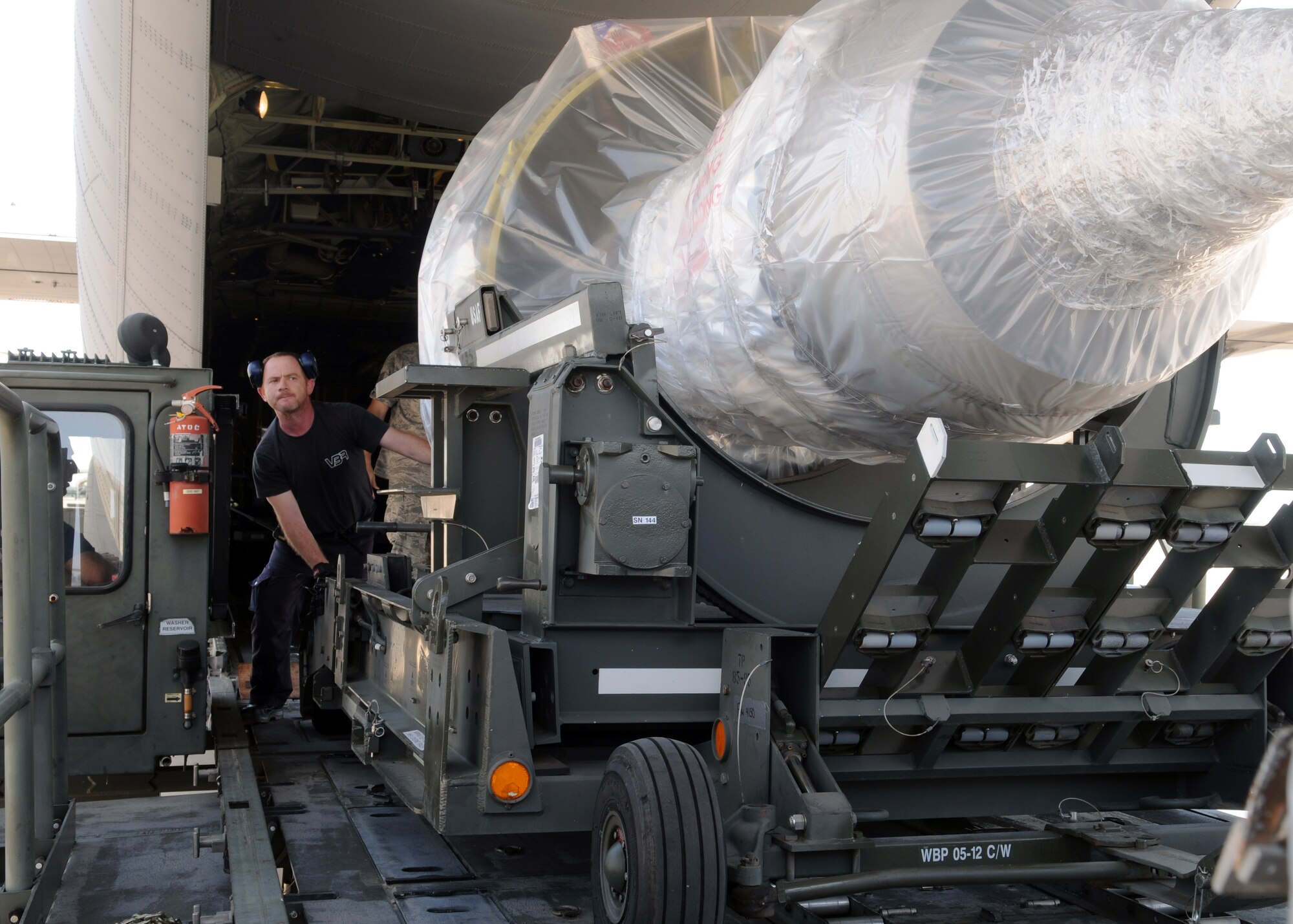 Personnel load a General Electric CFM-56 engine onto a K-Loader April 20, 2013, in Southwest Europe. The engine was delivered via a C-130J Super Hercules and used to replace the No. 4 engine on a KC-135R Stratotanker with the 351st Expeditionary Air Refueling Squadron after it was damaged by a bird while landing. (U.S. Air Force photo by 1st Lt. Christopher Mesnard/Released)