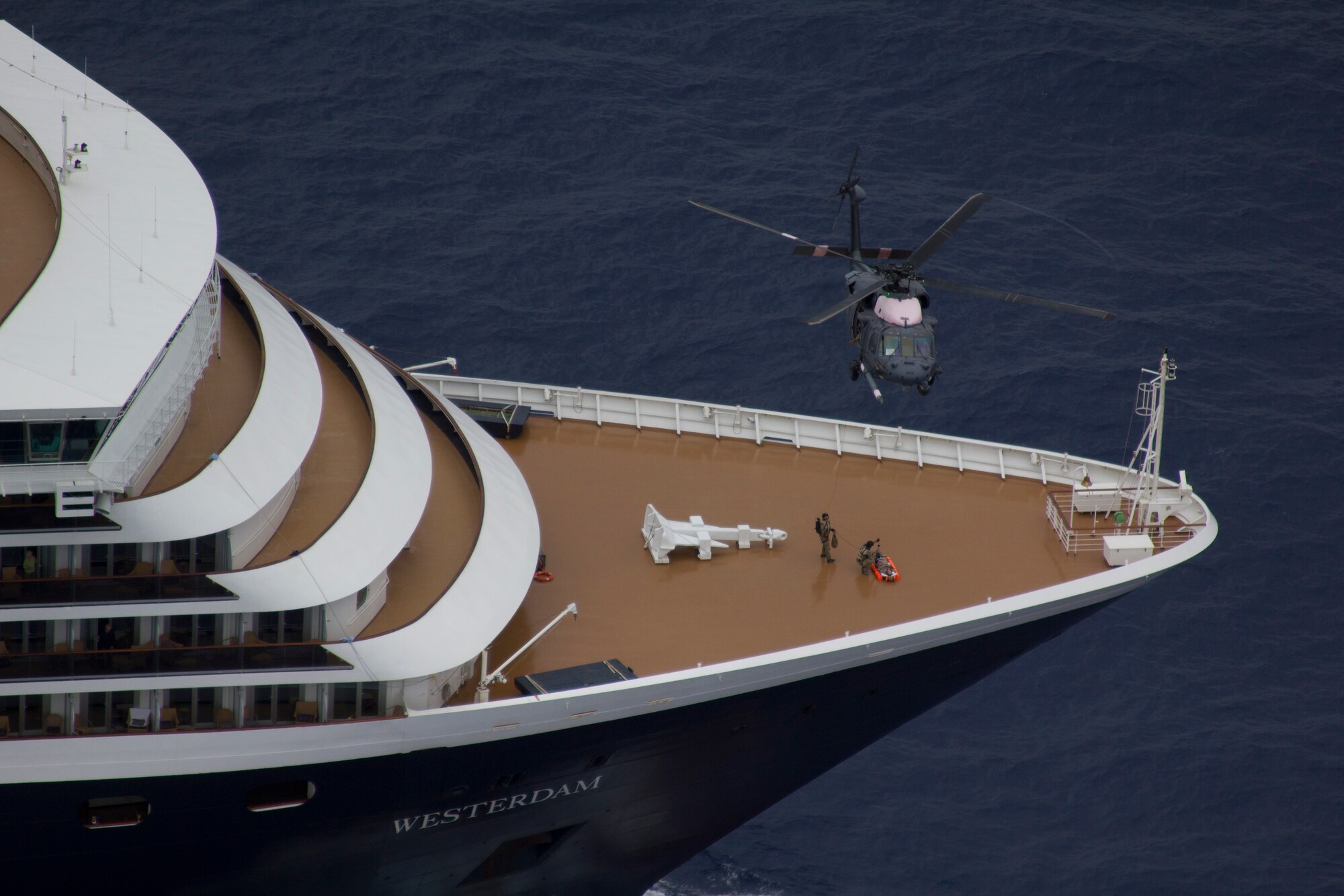 129th Rescue Wing and 58th Rescue Squadron Pararescuemen hoist a passenger off the bow of the Holland America cruise ship, ms Westerdam.  The passenger became seriously ill on Saturday, requiring medical treatment beyond the capabilities of the ship's medical staff.  Once rescued the passenger was flown to San Diego, Calif. for further medical treatment. The 129th RQW Airmen are based at Moffett Federal Airfield, Calif. and the 58th RS Airmen are based at Davis-Monthan Air Force Base, Ariz. (Air National Guard photo by Master Sgt. Miguel Toro)


