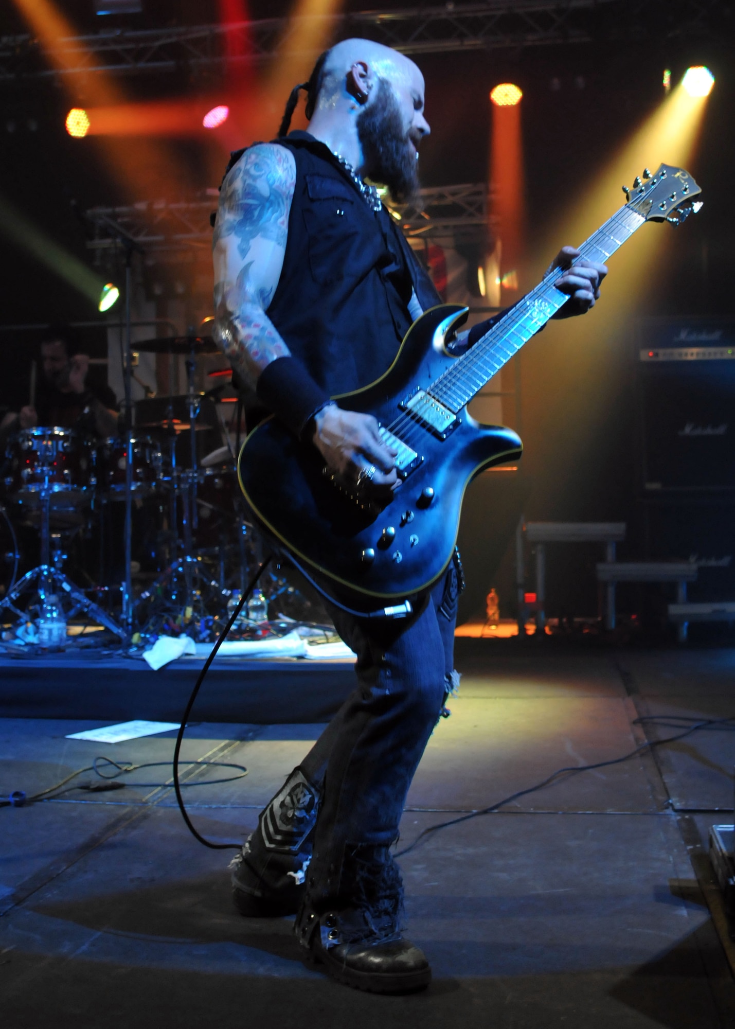 C.J. Pierce, Drowning Pool guitarist, plays a solo during the Drowning Pool concert May 3, 2013, at RAF Mildenhall, England. The concert, sponsored by the USO, helped raise morale for Team Mildenhall. (U.S. Air Force photo by Airman 1st Class Kelsey Waters/Released)