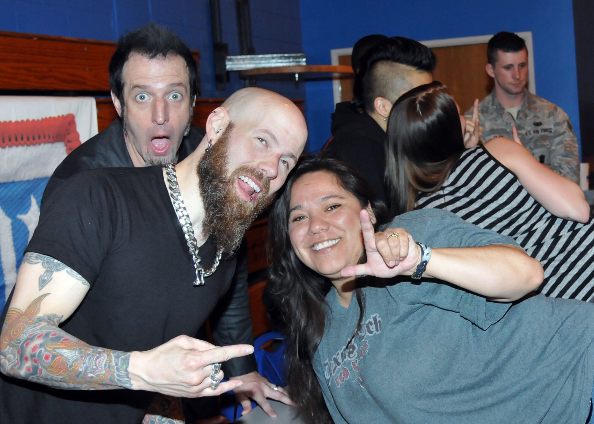 Members of Drowning Pool take a photo with Angelica Sill, wife of Master Sgt. Jerrit Sill, 352nd Special Operations Support Squadron section chief of data systems from The Colony, Texas, May 3, 2013, at RAF Mildenhall, England. The band visited the base during the USO-leg of their European tour. (U.S. Air Force photo by Airman 1st Class Kelsey Waters/Released)