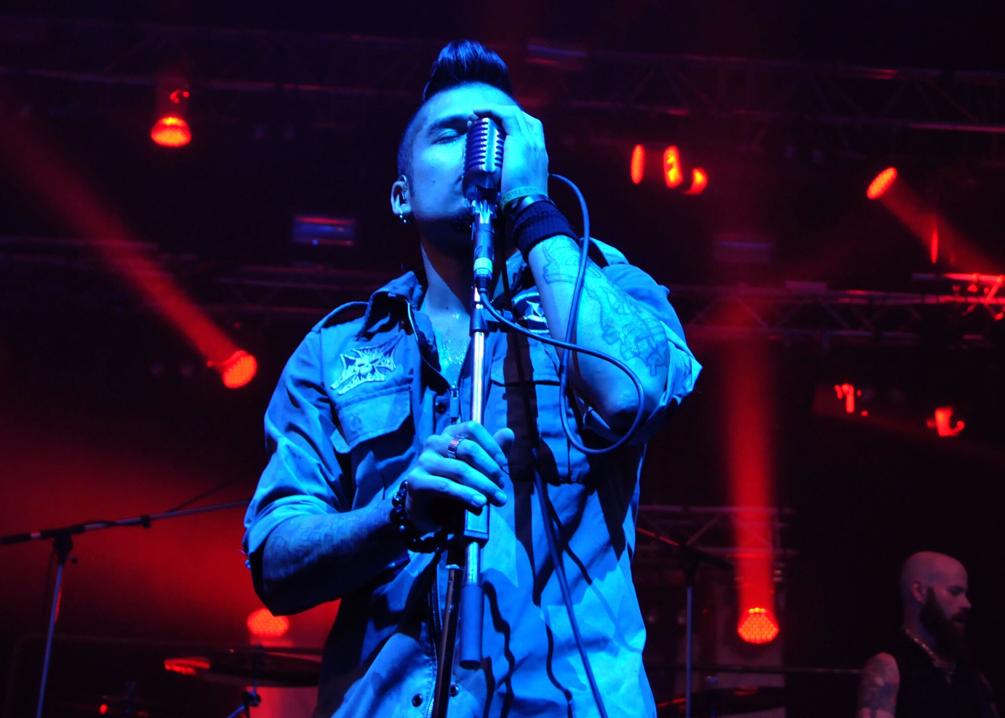 Jasen Moreno, Drowning Pool lead singer, serenades members of Team Mildenhall during the May 3, 2013, concert at RAF Mildenhall, England. The basketball court in the Northside Fitness center on base was transformed into a concert venue for the event. (U.S. Air Force photo by Airman 1st Class Kelsey Waters/Released)