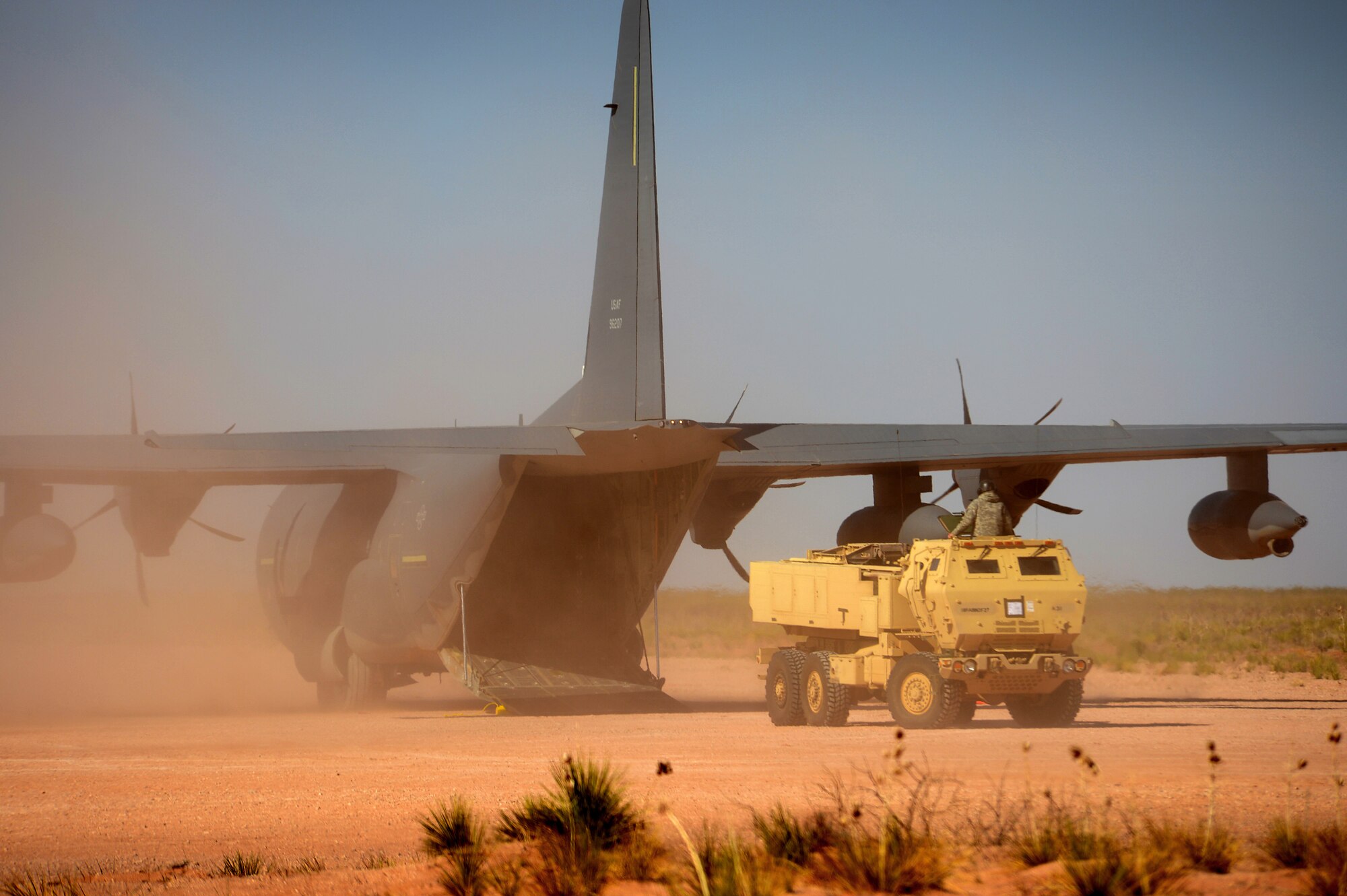 A High Mobility Artillery Rocket System (HIMARS) crew boards a MC-130J Commando II aircraft at Melrose Air Force Range N.M. in support of Emerald Warrior April 24, 2013. Emerald Warrior simulated special operations components in urban and irregular warfare settings.The exercise leveraged lessons learned from Operation Iraqi Freedom, Operation Enduring Freedom and other historical events to provide combatant commanders with a better-trained and ready force. (U.S. Air Force photo/ Staff Sgt. Matthew Plew)
