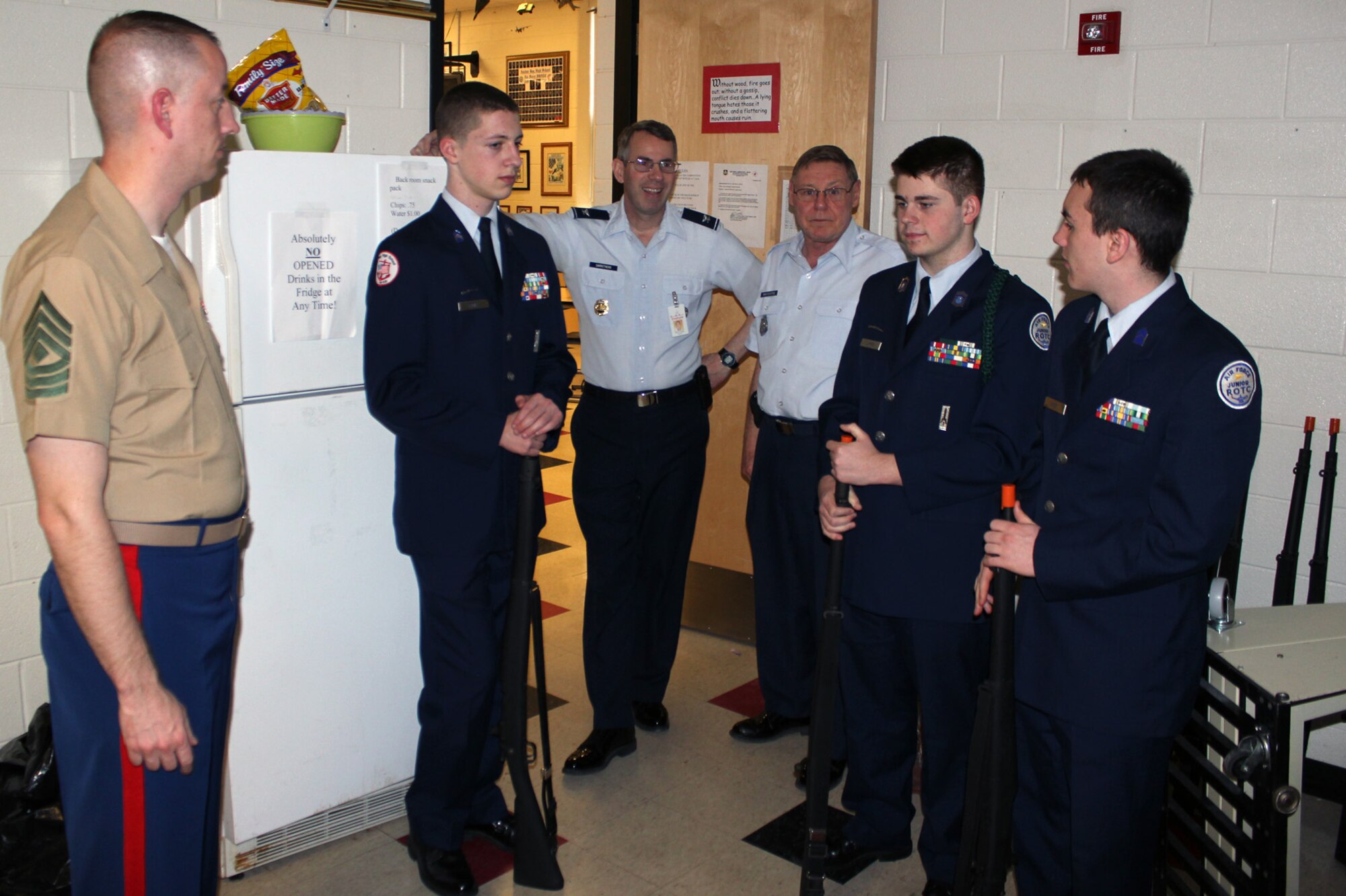 Marine Corps 1st Sgt. David Auwen talks with instructors and cadets of the Anchor Bay High School Air Force Junior ROTC program at the high school, near New Baltimore, Mich, April 24, 2013. Auwen was the first cadet commander of the program when it was re-established in the early 1990s. Today, he is the headquarters first sergeant for the 1st Battalion, 24th Marine Regiment, based at nearby Selfridge Air National Guard Base. With Auwen are Cadet Austin Parks, Col. (retired) Jeffrey Carrothers, Master Sgt. (retired) Steve Wratchford, and Cadets Johnathon LaFave and Tristan Grose. Carrothers and Wratchford are the aerospace science instructors at the high school. (U.S. Air National Guard photo by TSgt. Dan Heaton)