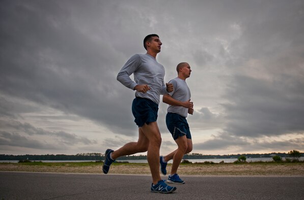 Senior Airman Chris Gauthier and Airman 1st Class Thomas Church, from the 96th Communications Squadron, jog around Post’l Point May 2 at Eglin Air Force Base, Fla.  The two Airmen are ultra-marathoners and just completed a 12-hour, more than 50 mile charity run May 4.  (U.S. Air Force photo/Samuel King Jr.)