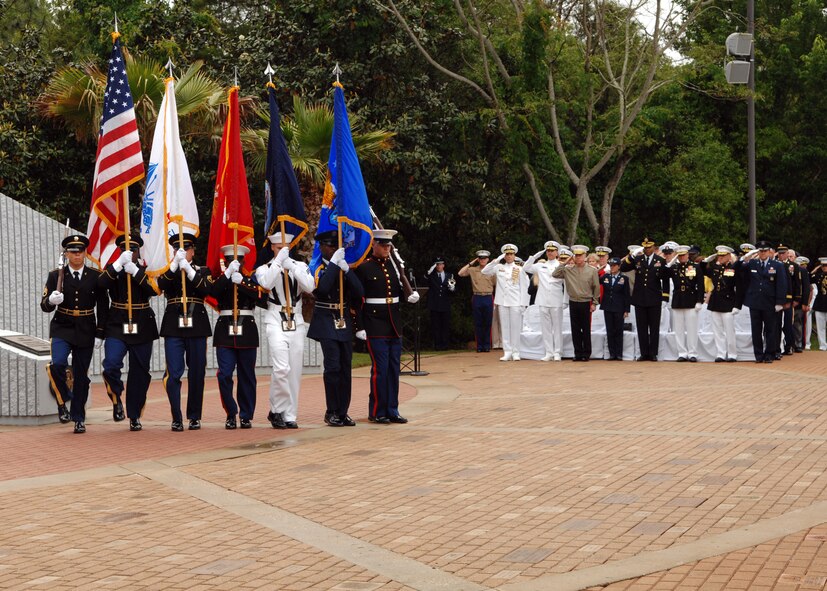 Distinguished guests salute the colors at the 44th Annual Explosive Ordnance Disposal Memorial Ceremony May 4 at Eglin Air Force Base, Fla. The ceremony, which took place across from the Kauffman EOD Training Complex, Naval School Explosive Ordnance Disposal honored EOD technicians who made the ultimate sacrifice for their country in performance of EOD missions.  (U.S. Navy photo/Lt. j.g. Elizabeth Allen) 