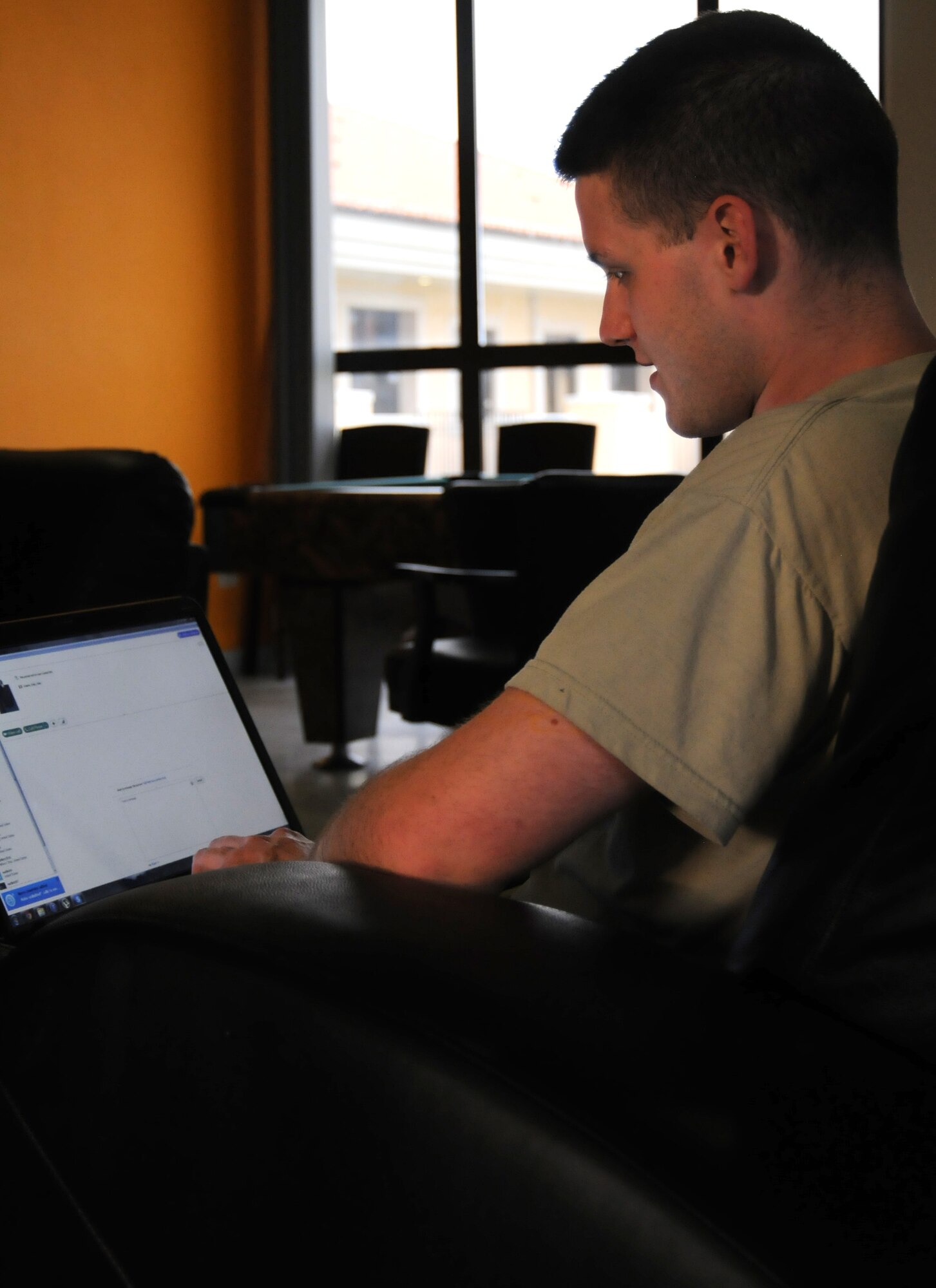 Airman 1st Class Joshua Blackburn, American Forces Network broadcast journalist, connects with friends on Skype April 29, 2013, at Aviano Air Base, Italy. Airmen living in the dormitories have access to free Wi-Fi in the dayroom and laundry room to communicate with family and friends. (U.S. Air Force photo/Airman Ryan Conroy)