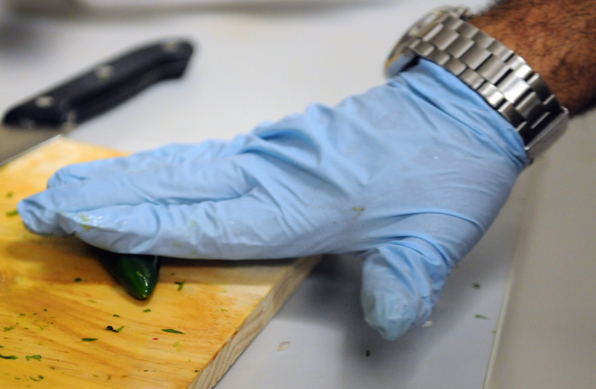 Master Sgt. John P. Garcia Jr, Air Forces Central vehicle fleet manager, and native of Los Angeles, Calif., rolls a jalepeno under his hand May 3 at an undisclosed location in Southwest Asia. This breaks up the veins inside and releases moisture to create a spicier jalapeno. (U.S. Air Force photo by Staff Sgt. Rachelle Elsea)