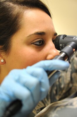 Senior Airman Shana Smith, 386th Expeditionary Medical Group, medical technician, trains with an otoscope May 5, 2013, in the medical clinic at the 386th Air Expeditionary Wing, Southwest Asia. (U.S. Air Force photo/Senior Master Sgt. George Thompson)