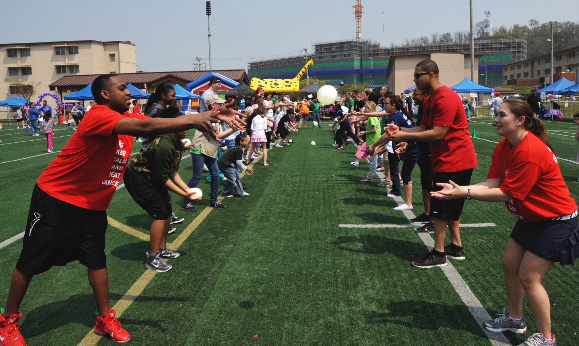 Participants toss water balloons during one of the many competitions at the Relay for Life walk at Osan Air Base, Republic of Korea, May 4-5, 2013. Other events included a 3-legged race, pie eating competition, scavenger hunt, tug o’ war, and musical chairs. (U.S. Air Force photo/Senior Airman Kristina Overton)