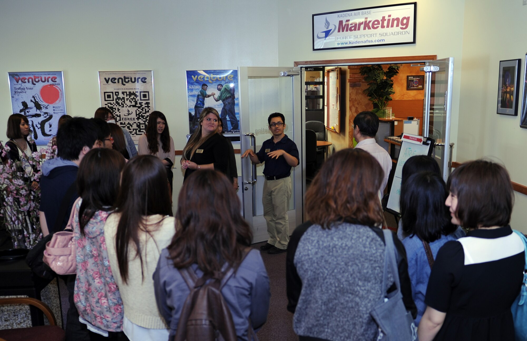 Att Eachus, 18th Force Support Squadron assistant director of marketing, answer questions asked by local Japanese college students from Okinawa International University on Kadena Air Base, Japan, May 3, 2013. The business students visited the 18th FSS marketing section to learn how they operate and how each section is crucial to the businesses overall success. (U.S. Air Force photo by Airman 1st Class Keith A. James/Released)