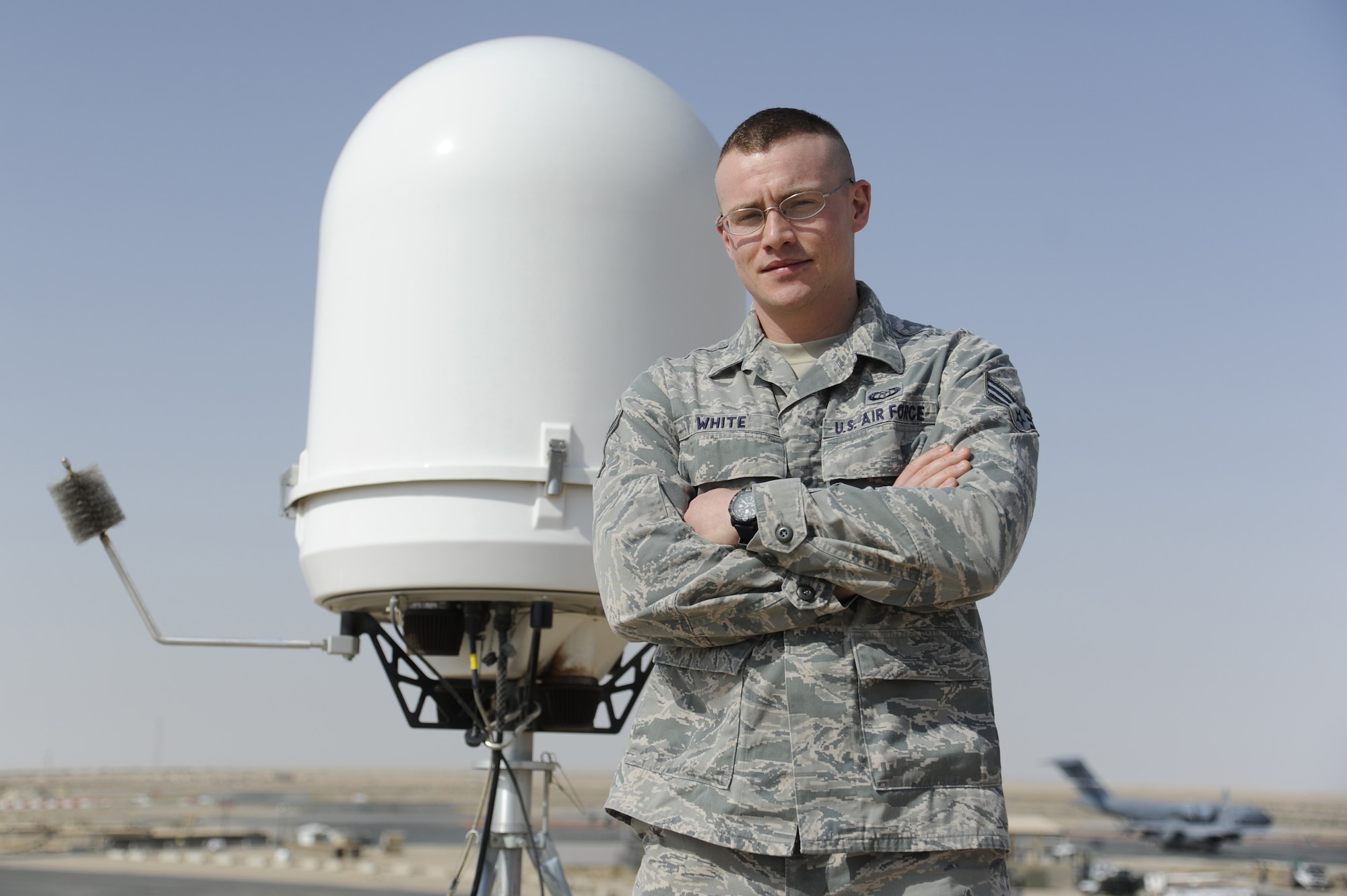 Senior Airman Erik White, 386th Expeditionary Operations Support Squadron, performs his duty as a weather forecaster next to the wings newly installed portable Doppler radar at the 386th Air Expeditionary Wing, Southwest Asia May 4, 2013. White was awarded this weeks "Rock Solid Warrior" designation by the 386th Top 3 Council.  White's job is to accurately predict the weather based on current conditions and weather models. "We have less information to work with out here and we have to get back to using some of our fundamental weather forecasting techniques to ensure accurate forecasts. In weather moisture plays a major role in what type of weather is seen or not seen." (U.S Air Force photo by Staff Sgt. Austin Knox)