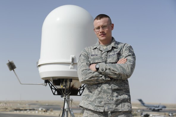 Senior Airman Erik White, 386th Expeditionary Operations Support Squadron, performs his duty as a weather forecaster next to the wings newly installed portable Doppler radar at the 386th Air Expeditionary Wing, Southwest Asia May 4, 2013. White earned the call sign ‘Sparky’ after he was struck by lightning in 2008. (U.S Air Force photo by Staff Sgt. Austin Knox)