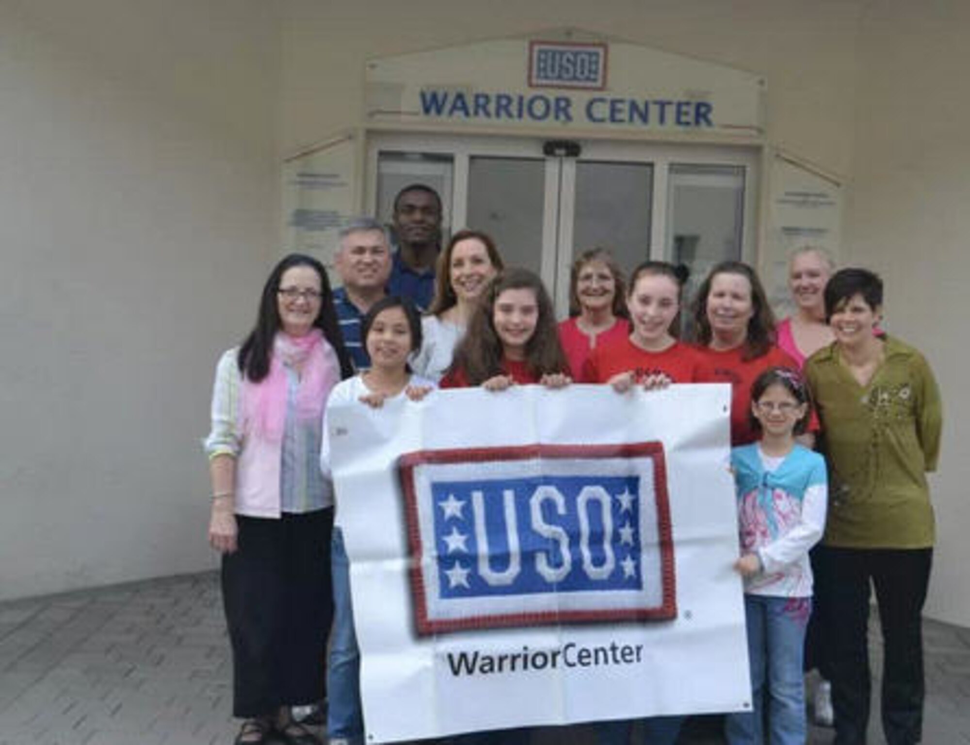 Nina Prince, Sophia Troutman and Kiana Murphy, take a photo outside the USO Warrior Center at Landstuhl Regional Medical Center. The Ramstein Intermediate School fifth-graders hosted a dinner at the center for the staff, and wounded men and women. (Courtesy photo)