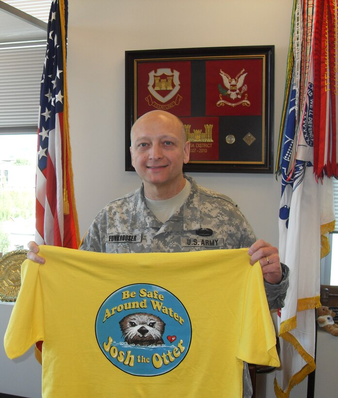 Northwestern Division Commander, Brig. Gen. Anthony C. Funkhouser displays his Josh the Otter t-shirt for National Water Safety Month and the Third Annual Otter Spotter Day.