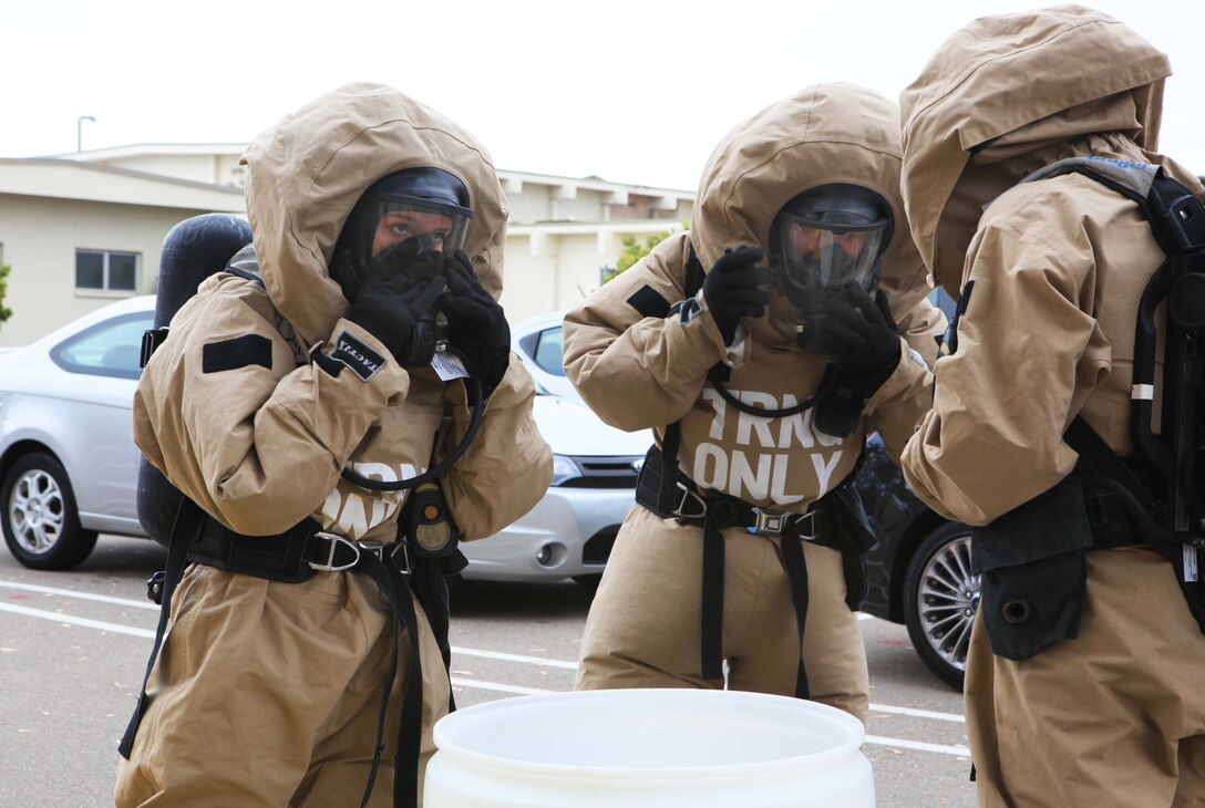 Marine Corps chemical, biological, radiological and nuclear defense specialists put on hazardous material suits during a training exercise on Marine Corps Air Station Miramar in San Diego, April 30, 2013. 