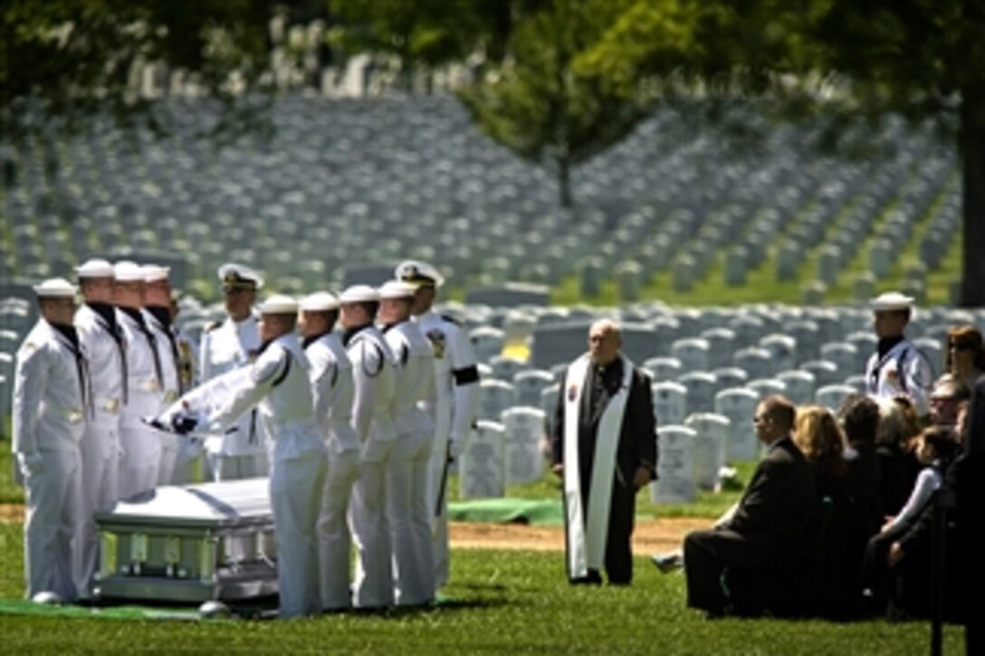 Members of the U.S. Navy Ceremonial Guard fold the American flag over the casket bearing the remains of sailors killed in the Vietnam War during a graveside interment ceremony at Arlington National Cemetery on May 2, 2013.  Lt. Dennis Peterson, from Huntington Park, Calif.; Ensign Donald Frye, from Los Angeles; and Petty Officers 2nd Class William Jackson, from Stockdale, Texas, and Donald McGrane, from Waverly, Iowa, were killed when their SH-3A Sea King helicopter was shot down on July 19, 1967, over Ha Nam Province, North Vietnam.  All four crewmembers were assigned to Helicopter Squadron 2.  