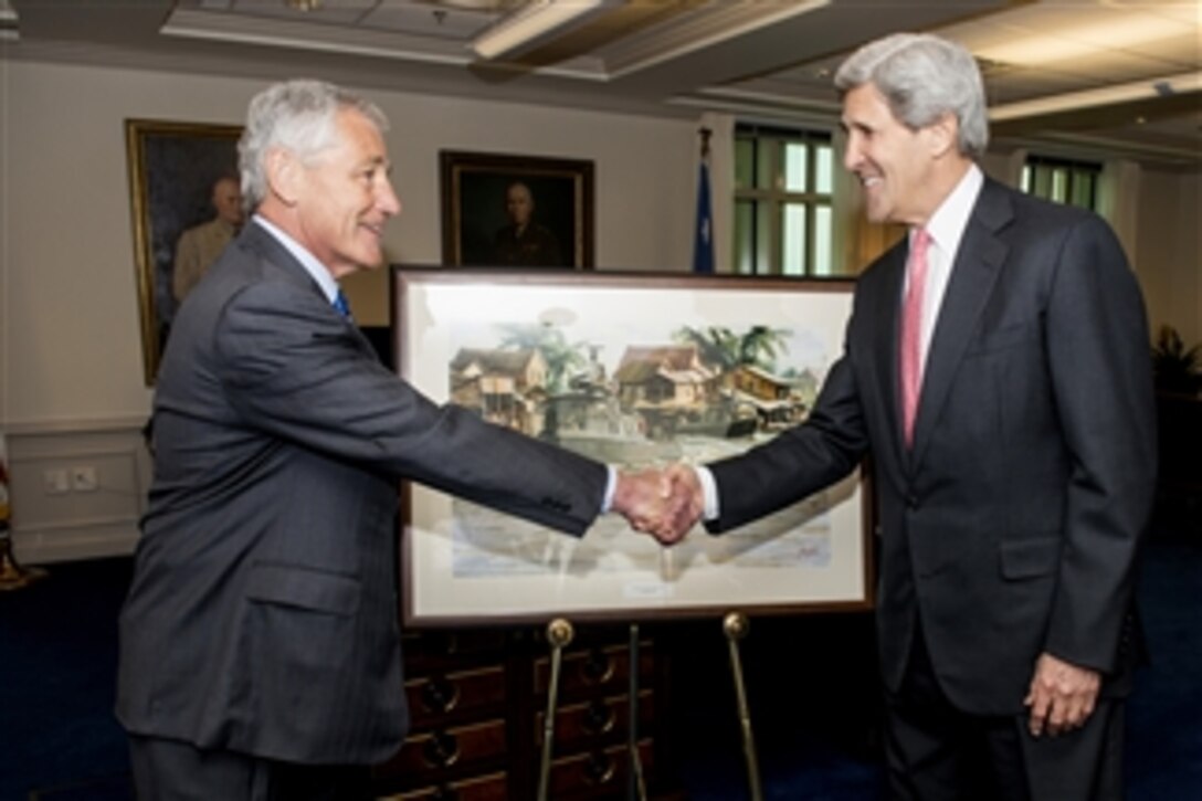 Secretary of Defense Chuck Hagel, left, and Secretary of State John Kerry shake hands after Hagel presented Kerry with a print from a painting depicting two Navy Patrol Craft Boats on the Mekong River Delta during a meeting in Hagel’s Pentagon office on May 6, 2013.  The original painting titled “Showing the Flag in Ca Mau (PT-71)” is by Gerland Merfeld and is part of the Department of the Navy’s art collection.  Kerry commanded these types of vessels during the Vietnam War.  Both Hagel and Kerry are Vietnam War combat veterans.  