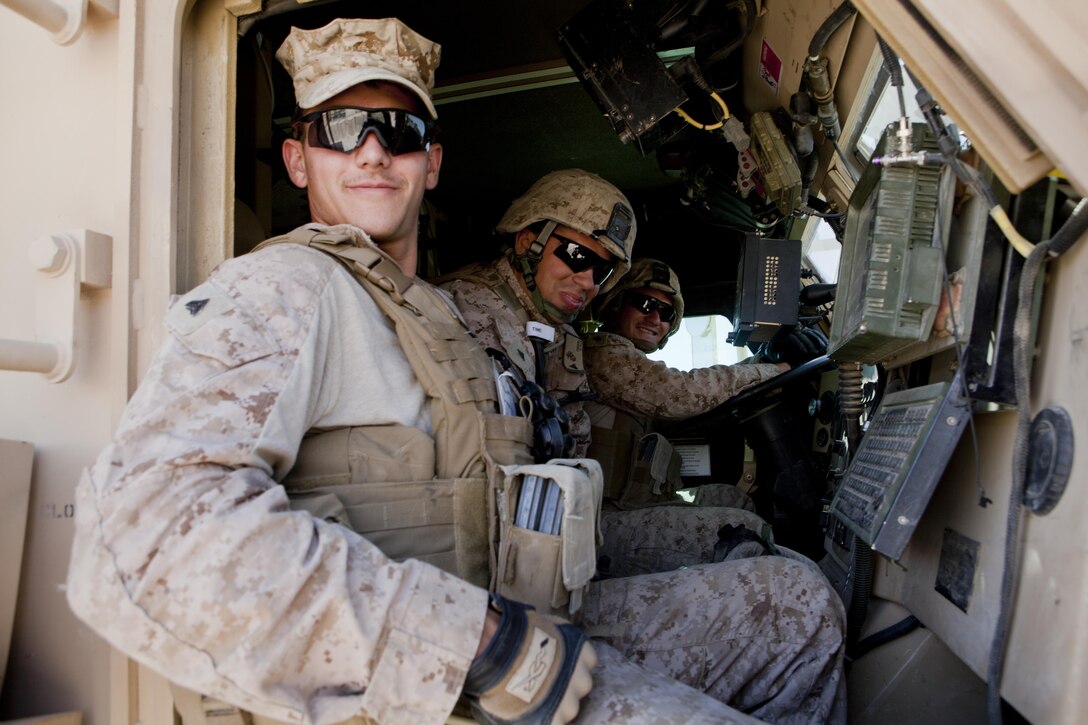 U.S. Marine Corps Cpl. Michael Perialas, left, a combat engineer, and Lance Cpls. Alexander Keezel, center, a combat engineer, and Arturo Cortez, a motor transport operator, all with 3rd Combat Engineer Battalion, sit in the front of a Mine Resistant, Ambush-Protected Vehicle at Forward Operating Base Shukvani, Afghanistan, April 5, 2013. Gen. John Paxton, the Assistant Commandant of the Marine Corps and other staff conducted a battlefield circulation to FOBs Shukvani, Shir Ghazay, Kajaki, and Delaram to meet with Marines and discuss important issues with key leaders. (U.S. Marine Corps photo by Sgt. Tammy K. Hineline/Released)