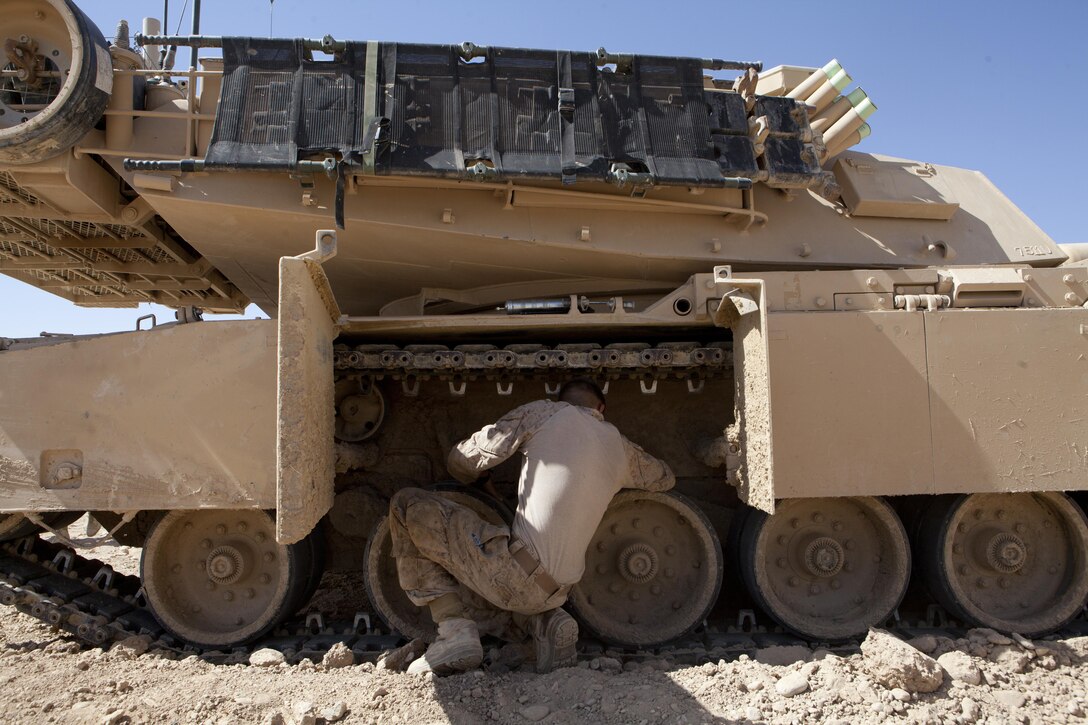 U.S. Marine Corps Lance Cpl. Brandon King, a driver with Delta Company, 1st Tank Battalion performs maintenance on an M1 Abrams Tank at Forward Operating Base Shir Ghazay, Afghanistan, April 5, 2013. Gen. John Paxton, the Assistant Commandant of the Marine Corps and other staff conducted a battlefield circulation to FOBs Shukvani, Shir Ghazay, Kajaki, and Delaram to meet with Marines and discuss important issues with key leaders. (U.S. Marine Corps photo by Sgt. Tammy K. Hineline/Released)