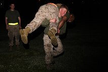 A Marine with 2nd Maintenance Battalion, Combat Logistics Regiment 25, 2nd Marine Logistics Group fireman’s carries a squad member during a battalion physical training competition aboard Camp Lejeune, N.C., April 26, 2013. Marines and sailors ran an approximately four-mile race, while stopping to perform squad-based exercises, which included squad push-ups and an obstacle course