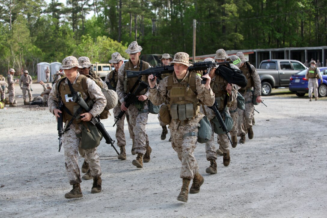 A squad of 13 Marines with 2nd Maintenance Battalion, 2nd Marine Logistics Group leaves the marksmanship test during a super squad challenge aboard Camp Lejeune, N.C., May 3, 2013. Servicemembers with the battalion went through many obstacles such as Marine Corps Martial Arts Program battle, simulated gas attack and assembly and disassembly of crew-served weapons contending to be the best squad out of the six competing. 
