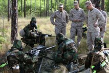 Lt. Col. Craig C. Clemans, commanding officer of 2nd Maintenance Battalion, 2nd Marine Logistics Group, and Sgt. Maj. Scott M. Schmitt, the battalion sergeant major, observe Marines with Electronics Maintenance Company, 2nd Maint. Bn. perform a functions check of the Mark 19 grenade launcher during the super squad challenge aboard Camp Lejeune, N.C., May 3, 2013. Electronics Maint. Co. won the super squad challenge, rewarding them with a three-day weekend and a meritorious mast for each member of the squad. 