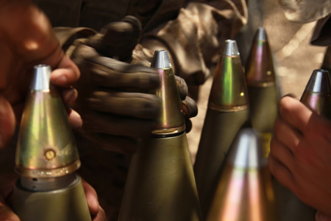 Marines with 5th Battalion, 14th Marine Regiment prepare 155 mm rounds to be loaded into an M777 A2 howitzer during a series of integrated firing exercises at the Combat Center’s Quakenbush Training Area April 26, 2013. (Official USMC photo by Cpl. William J. Jackson/Released)