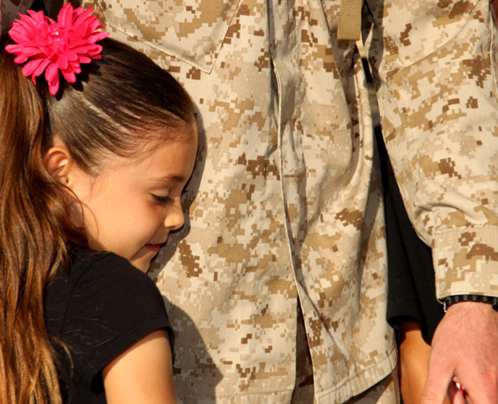 Mackayda Gilbert, 7, daughter of Sgt. Joshua Gilbert, imagery analyst, Marine Unmanned Aerial Vehicle Squadron-1, hugs her father
before he departs for Afghanistan April 27.