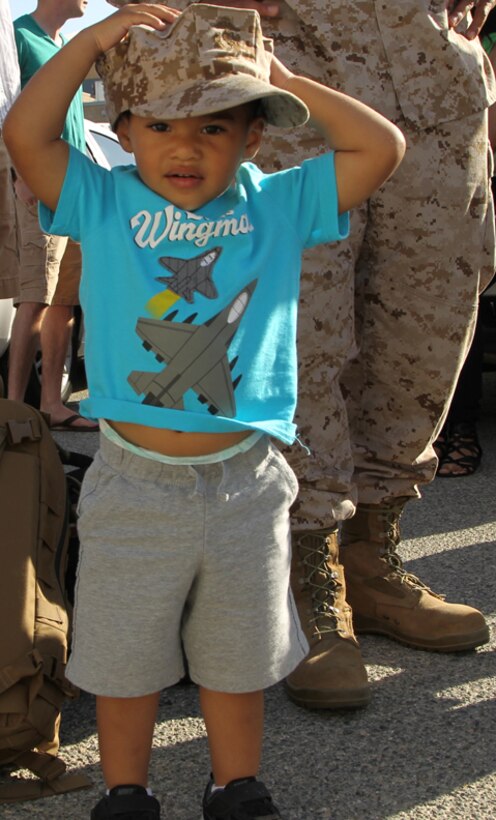 Aiden Gordon, son of Sgt. Antoine Gordon, imagery analyst, VMU-1,
tries on a Marine Corps cover before his father departs for Afghanistan
April 27.